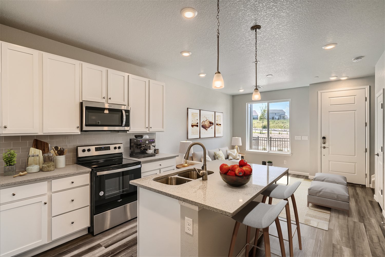 A kitchen with white cabinets.