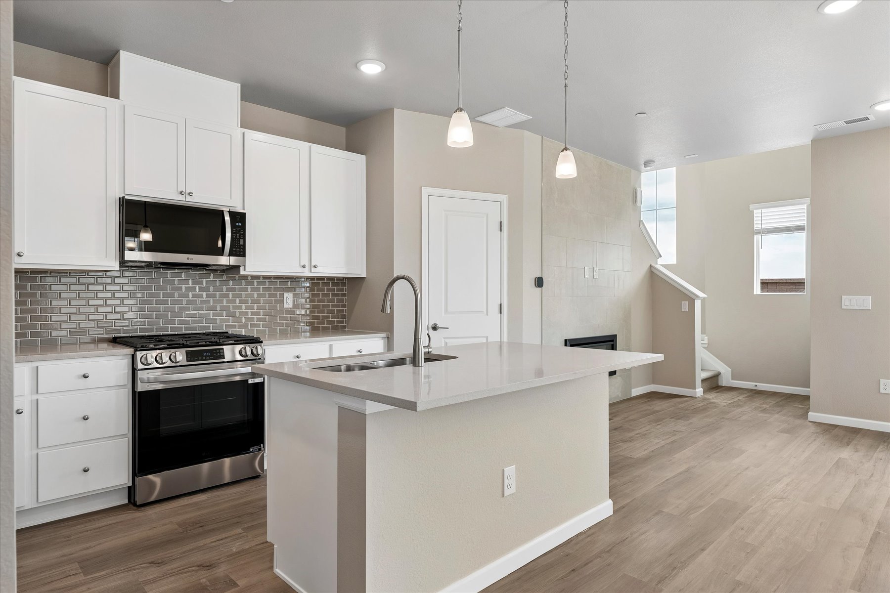 A kitchen with white cabinets.