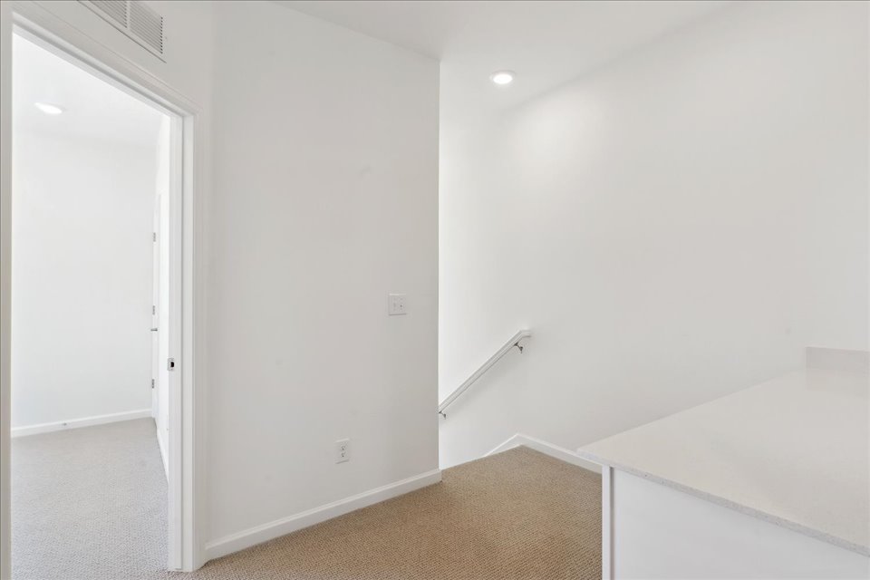 A room with a white wall and a white door.