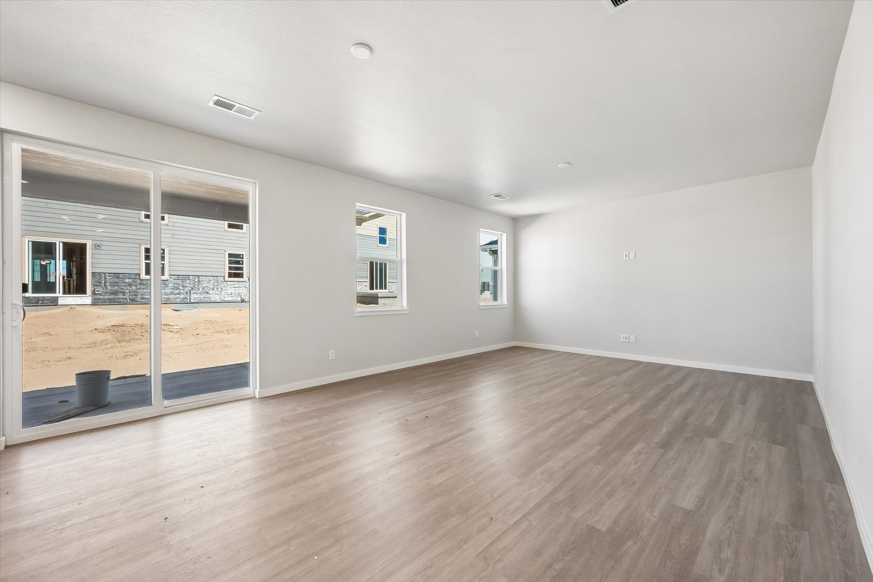 A room with a wood floor and a glass door.