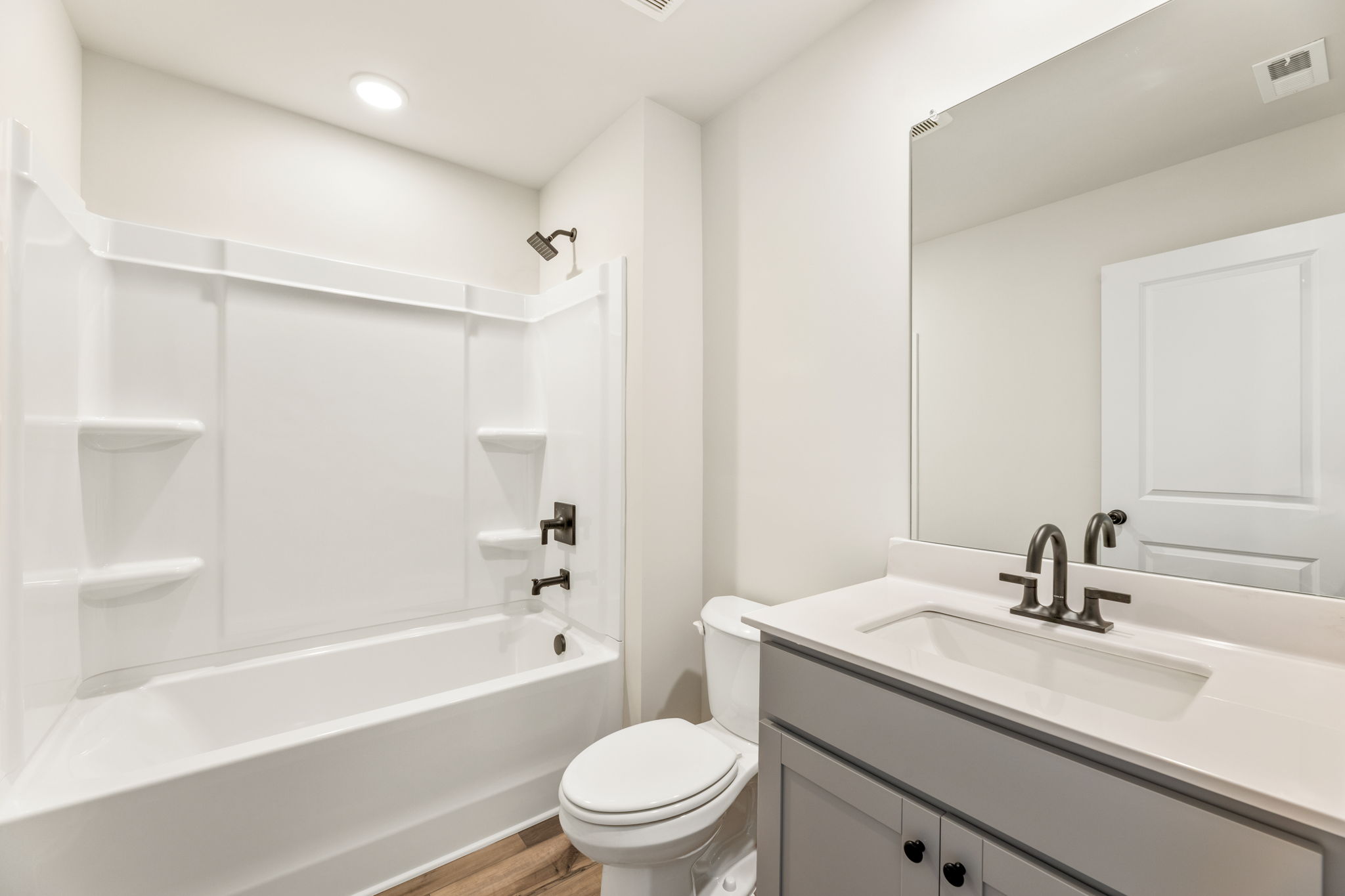 A bathroom with a tub sink and toilet.