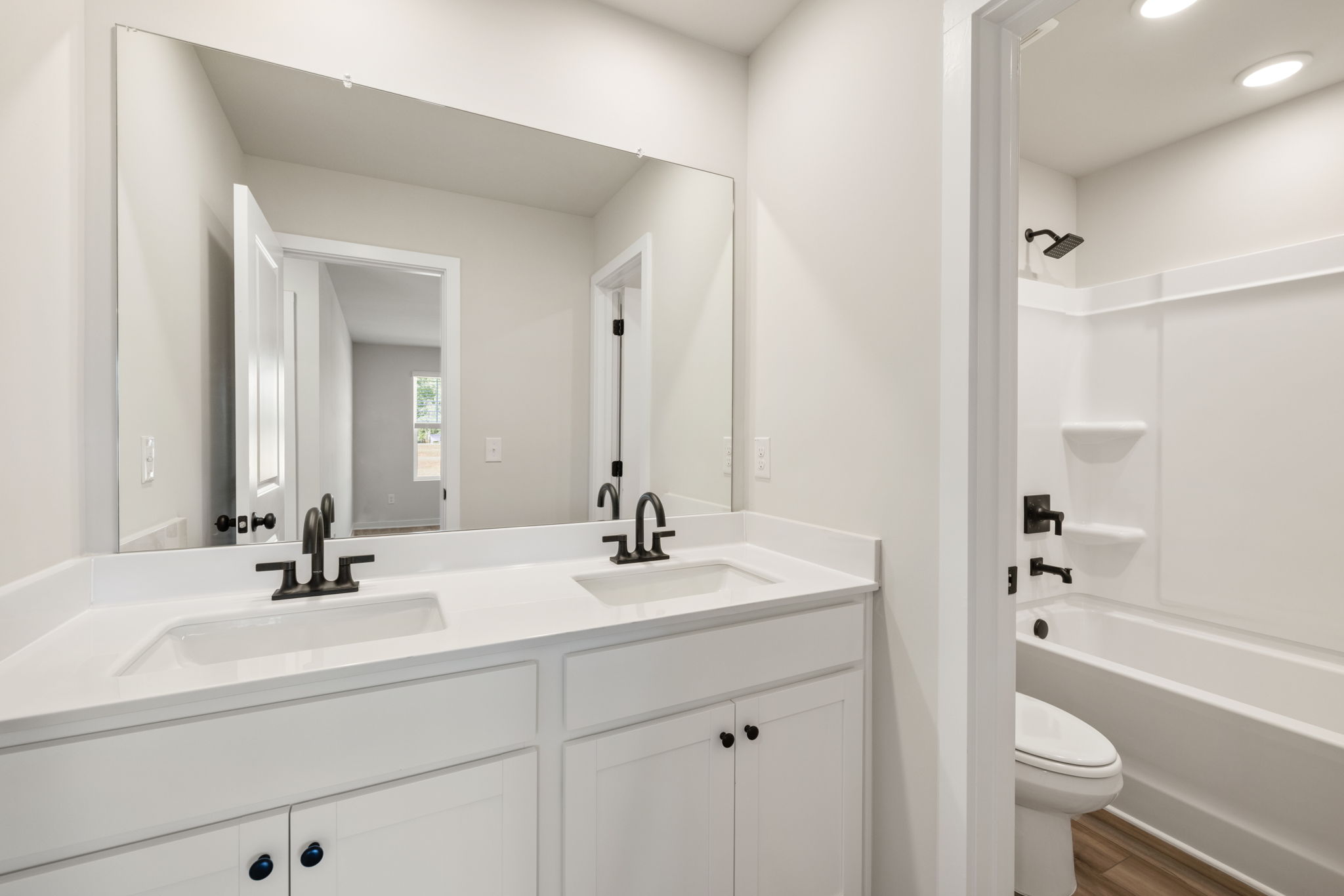 A bathroom with a tub sink and toilet.