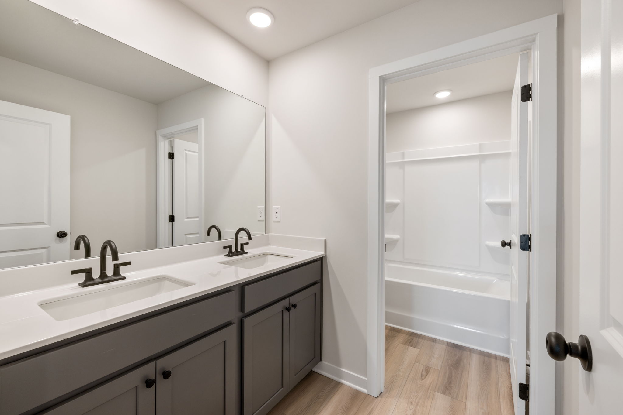A bathroom with a sink and a shower.