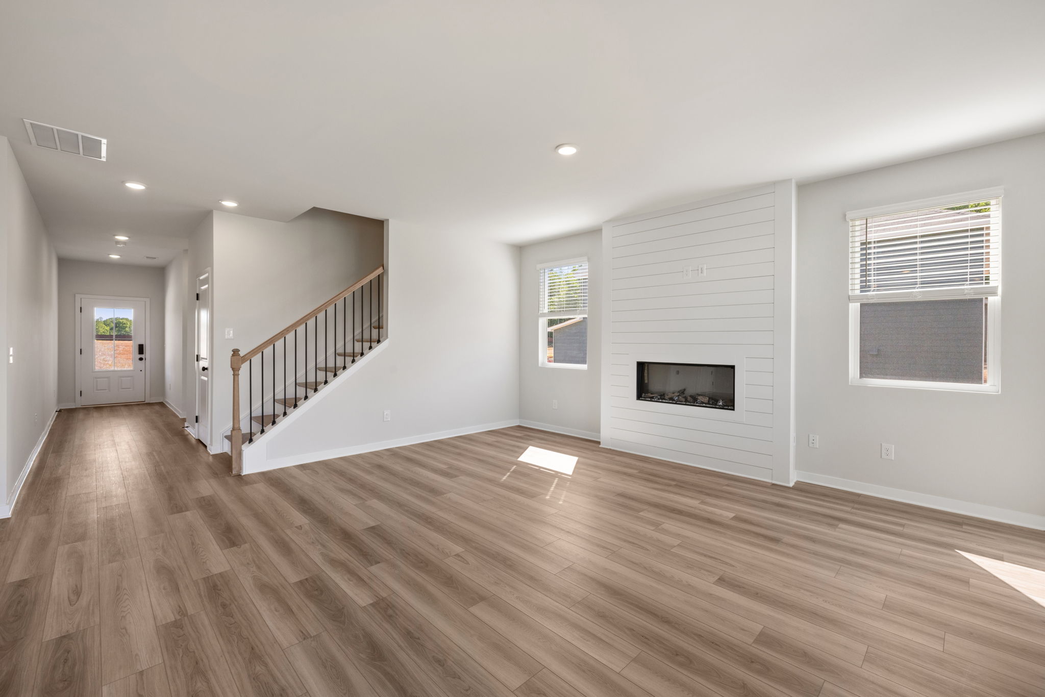 A room with a wood floor and white walls.