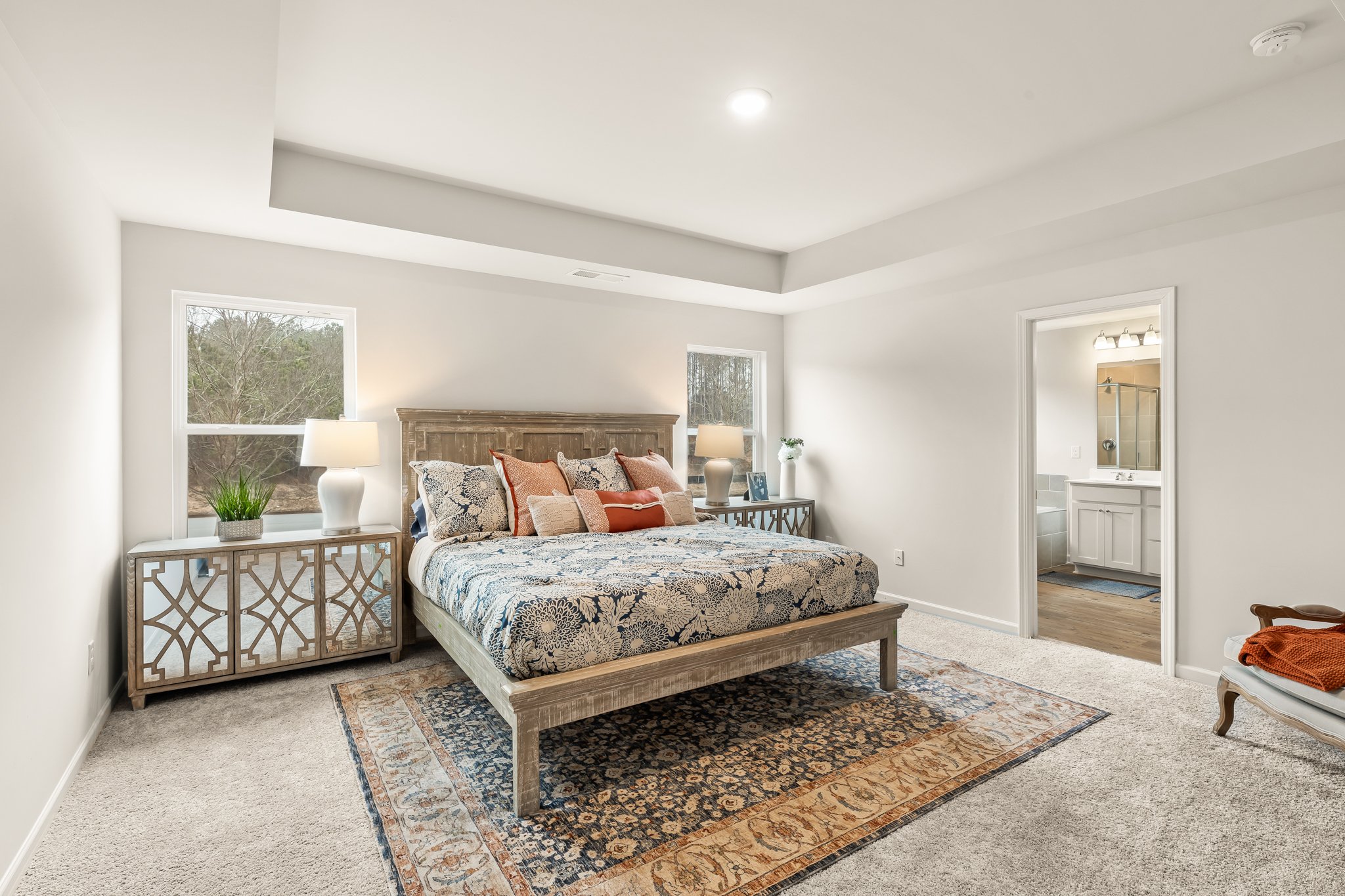 A bedroom with a bed and a table.