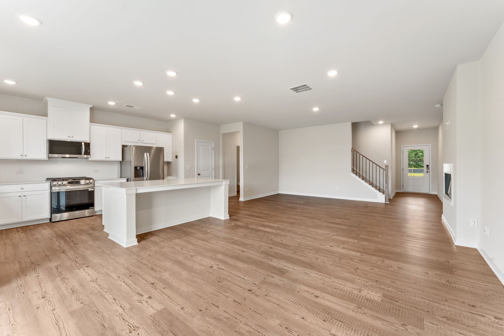 A large kitchen with white cabinets.