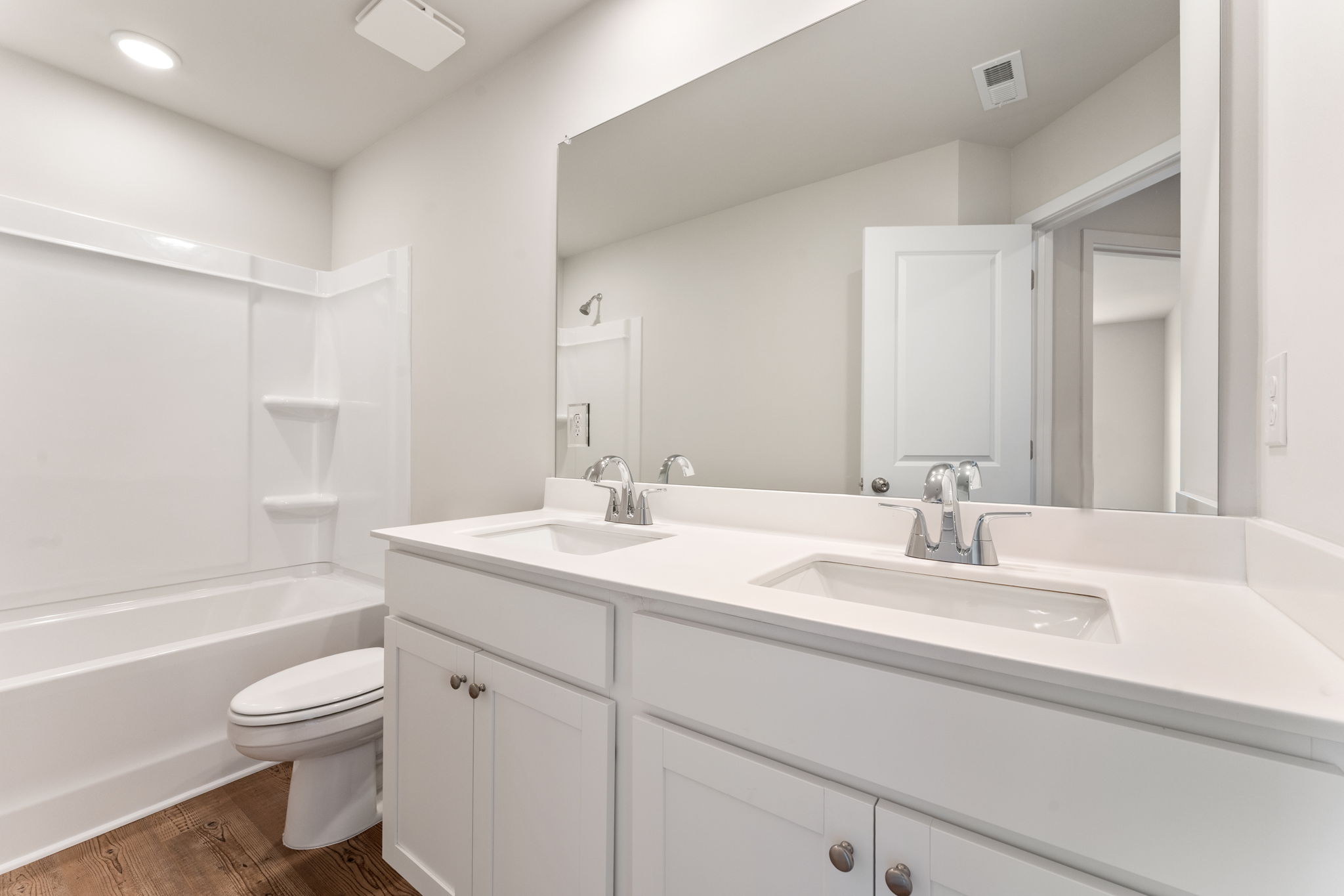 A bathroom with a tub sink and toilet.