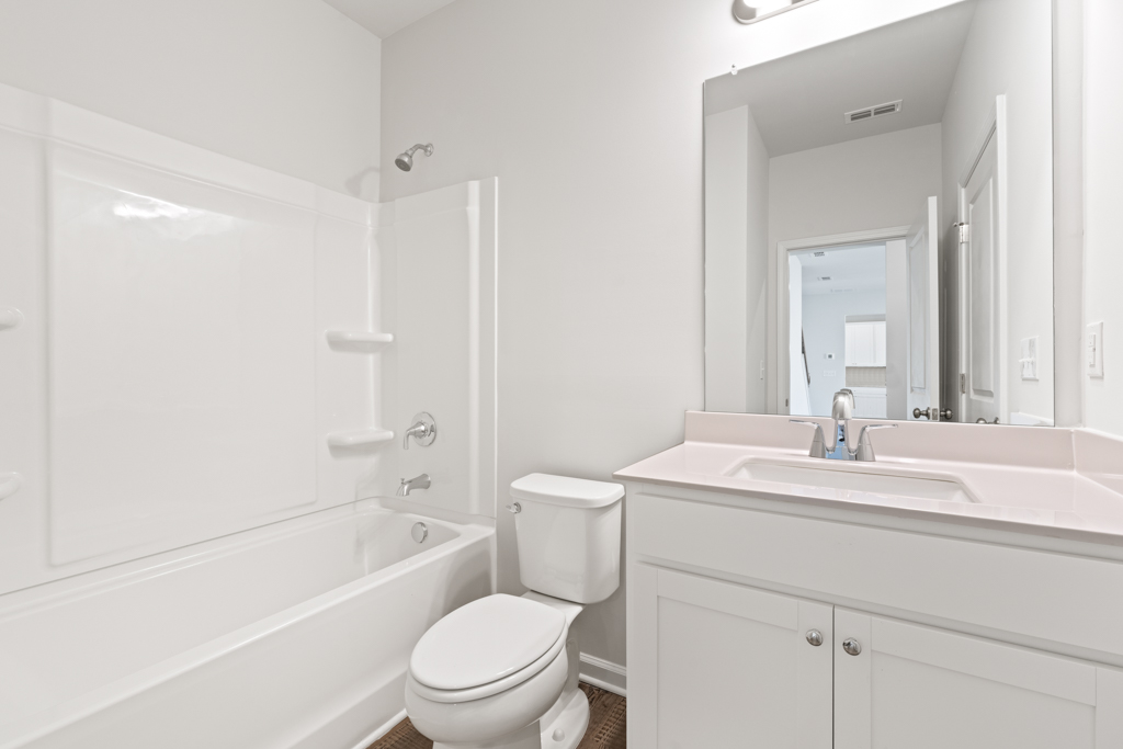 A bathroom with a toilet sink and bathtub.