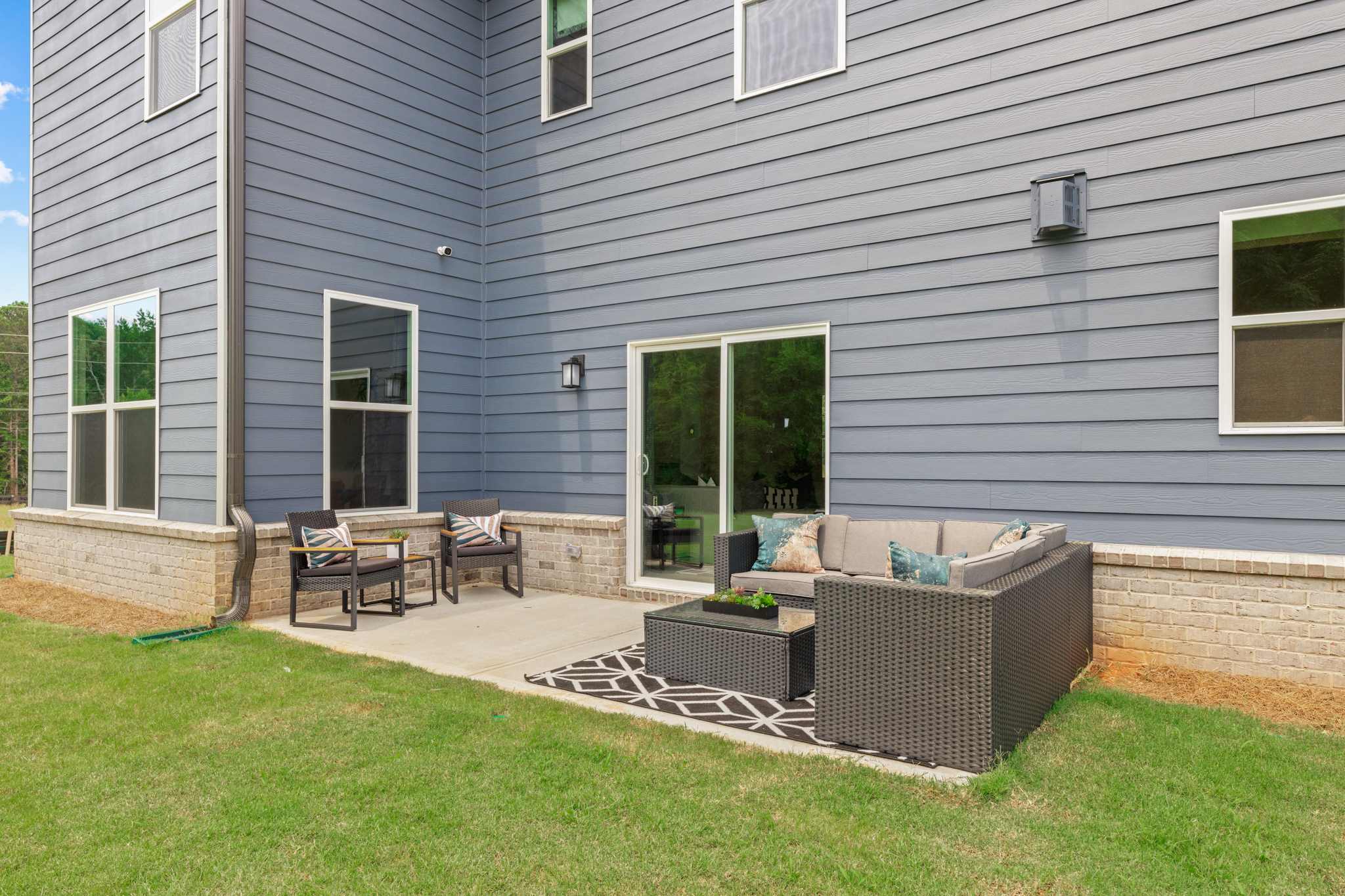 A backyard with a bench and a fireplace.