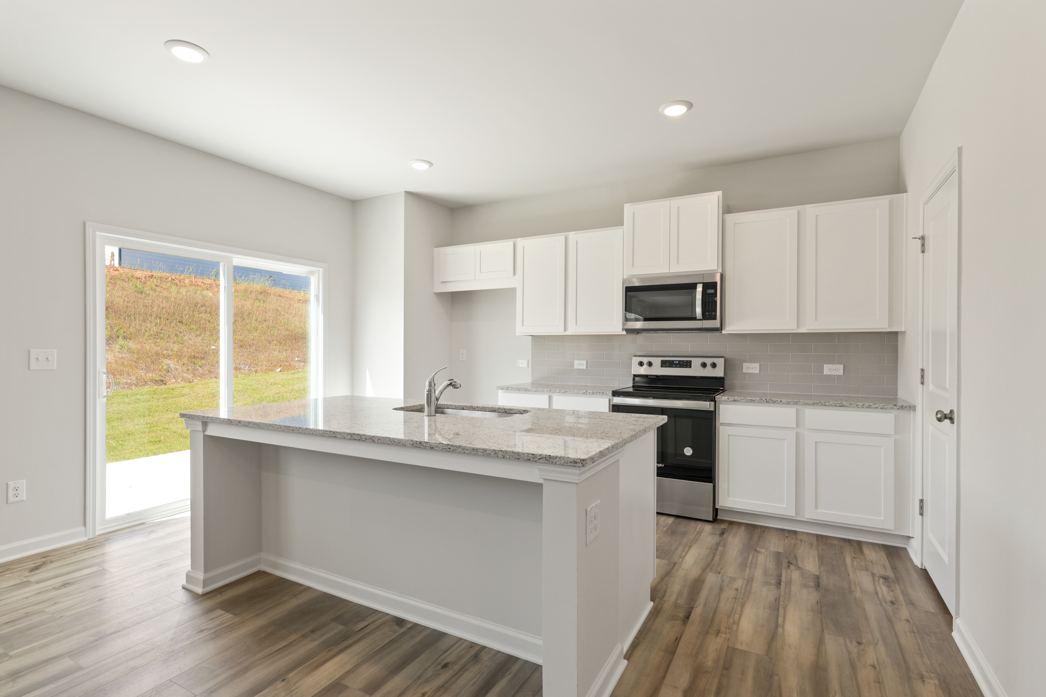 A kitchen with white cabinets.