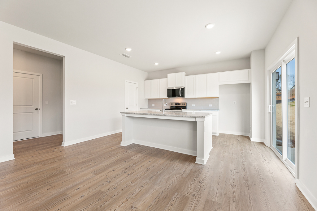 A kitchen with white cabinets.