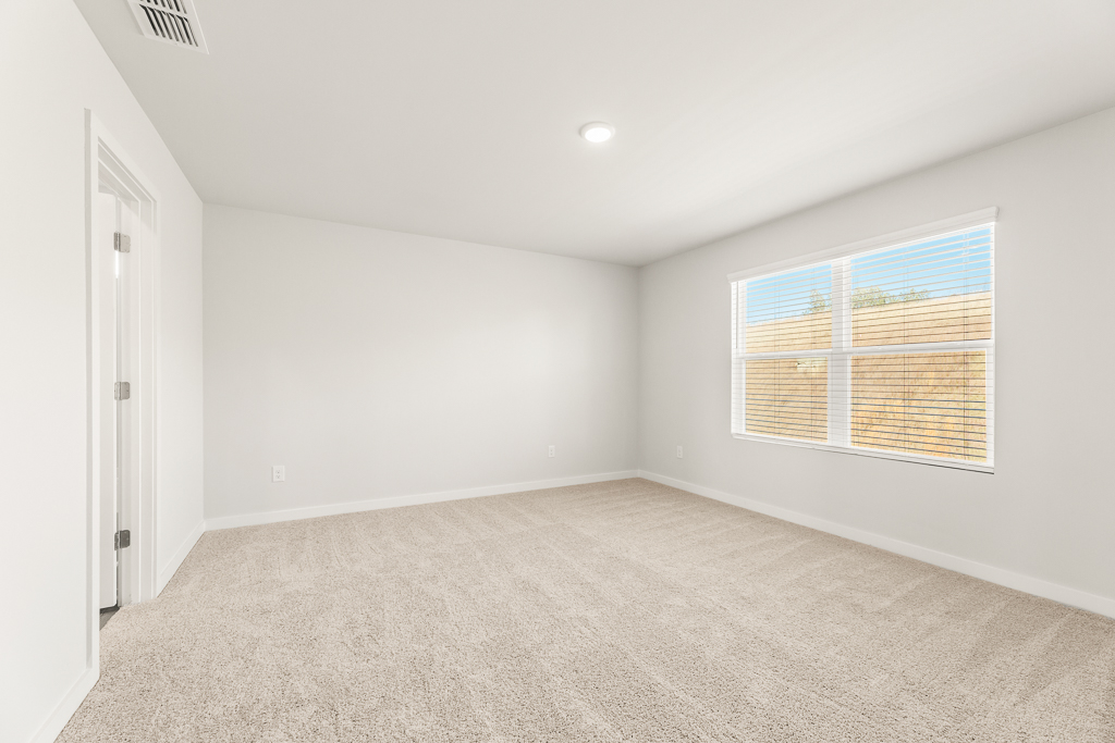 A room with a window and carpet.