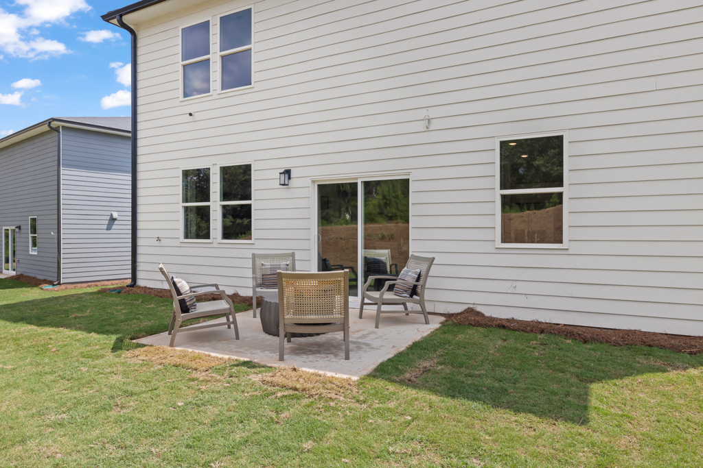 A couple of chairs outside a house.
