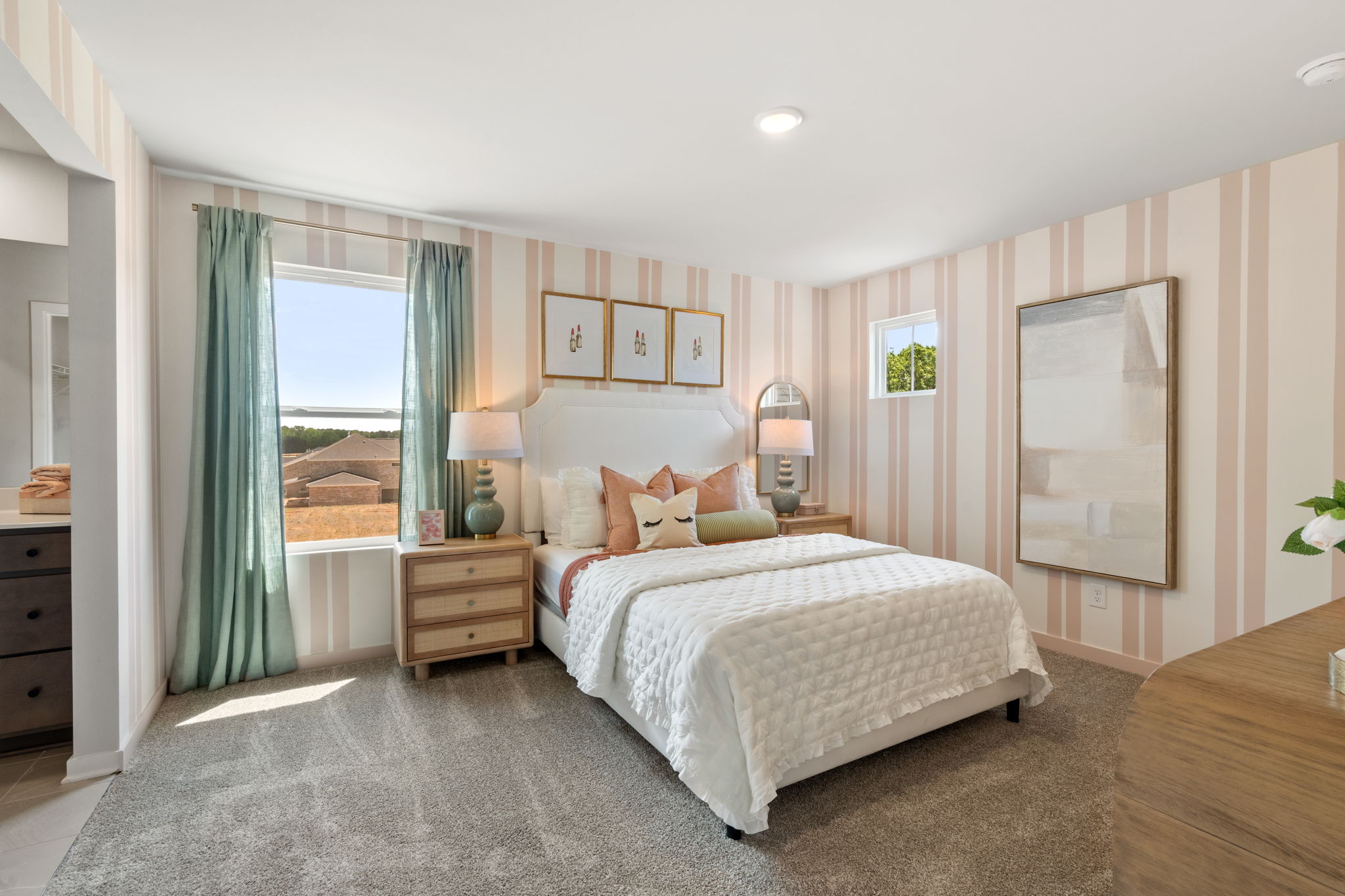 A bedroom with a large window.