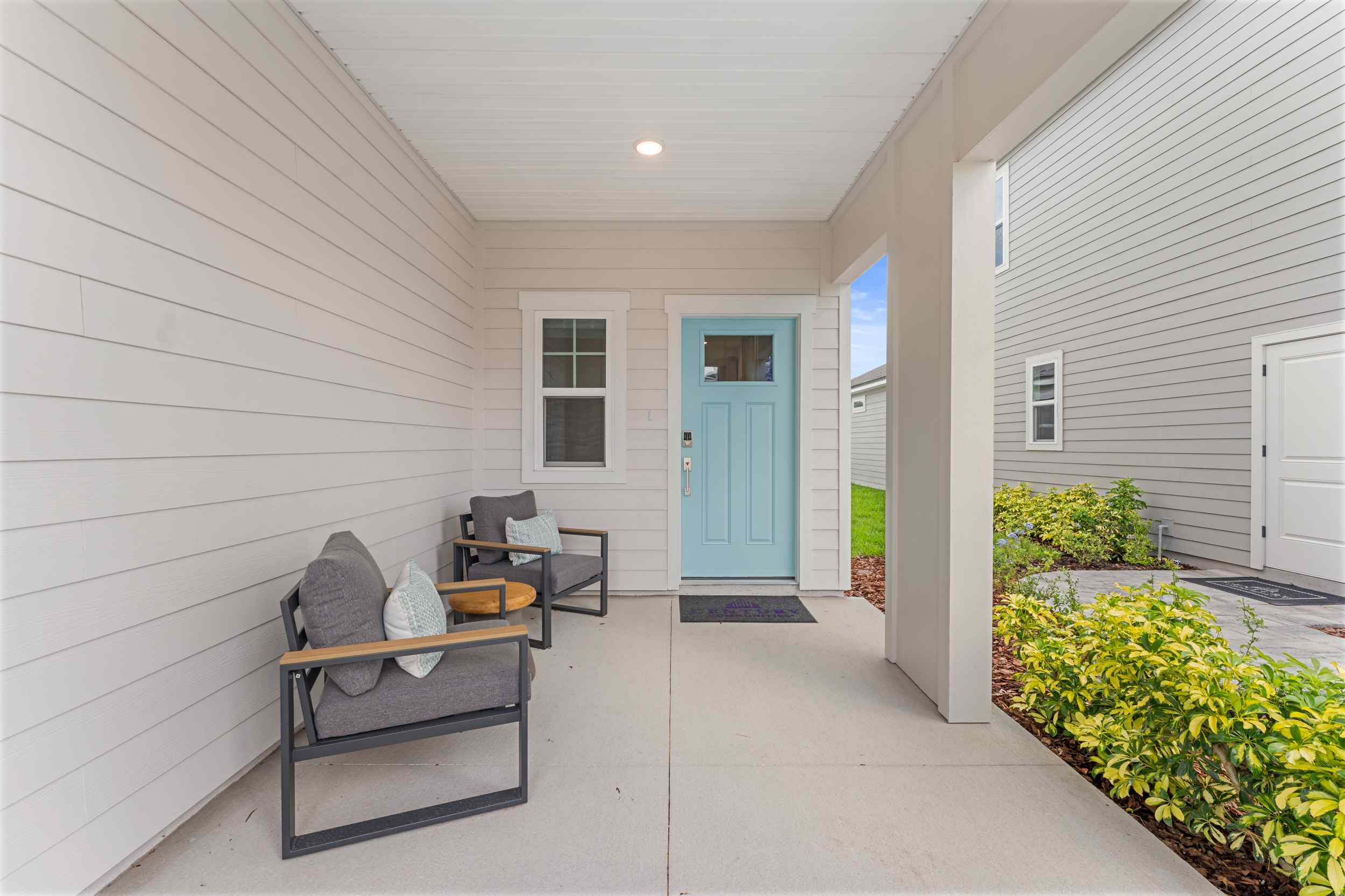 Laurel II Model Home Front Patio Entrance with Blue Door at Camden Woods in Kingsland, GA