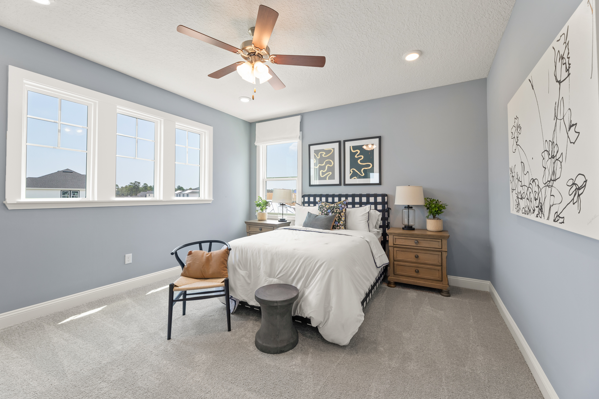 A bedroom with a bed and a fan.