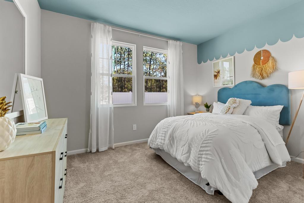 A bedroom with a bed and a desk.