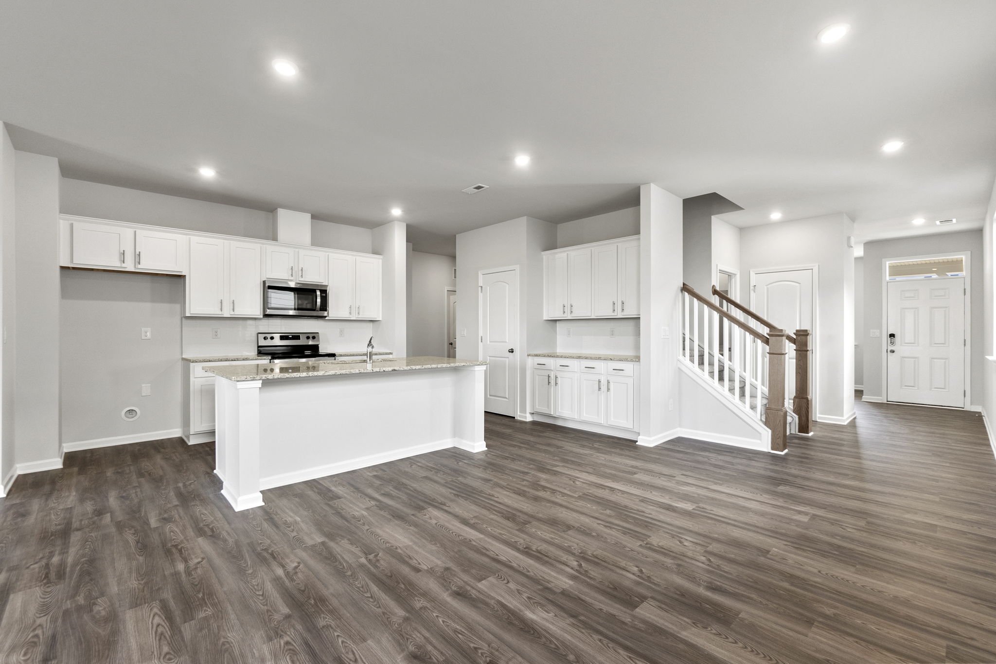 A large kitchen with white cabinets.
