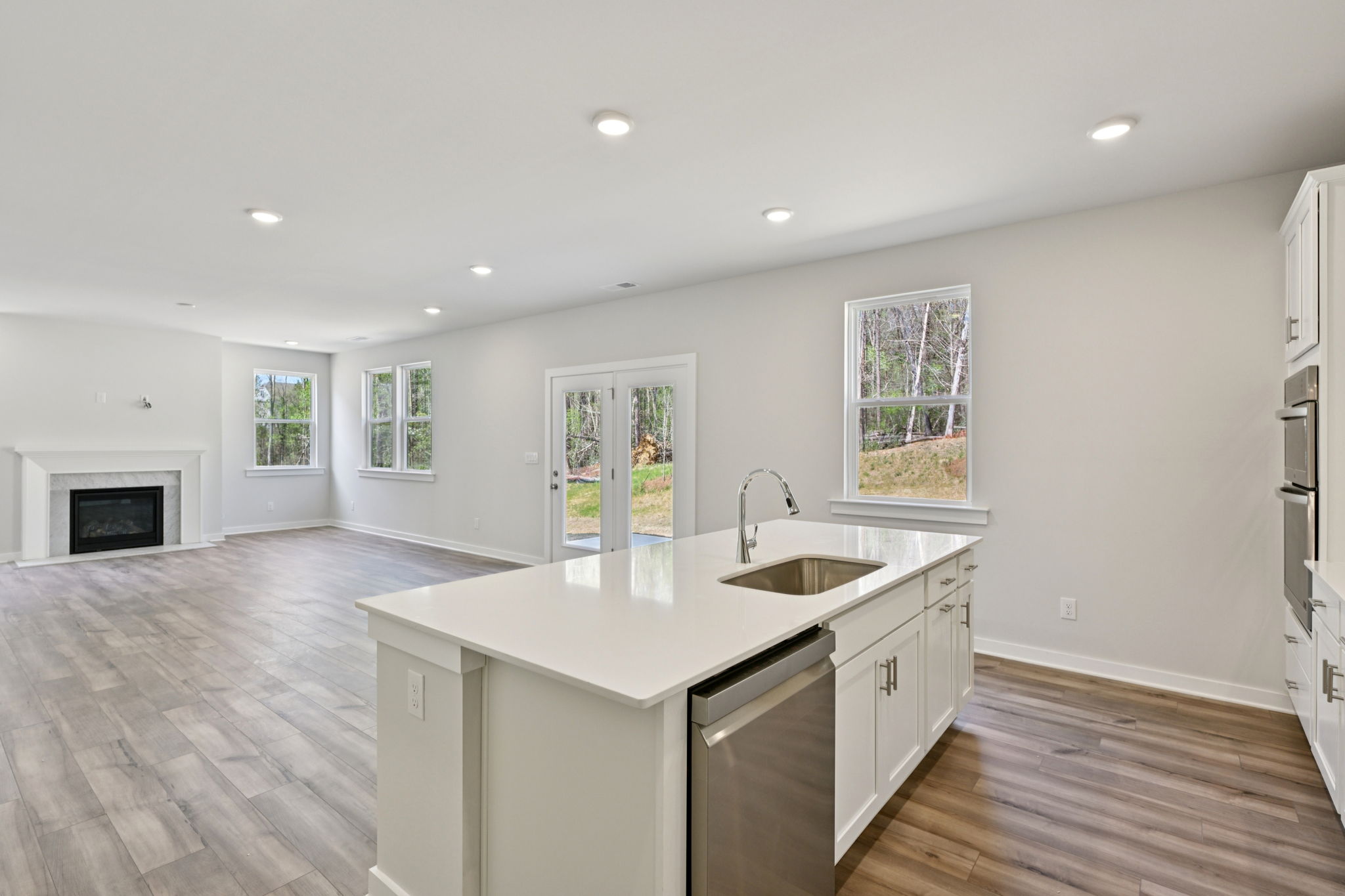 A kitchen with white cabinets.