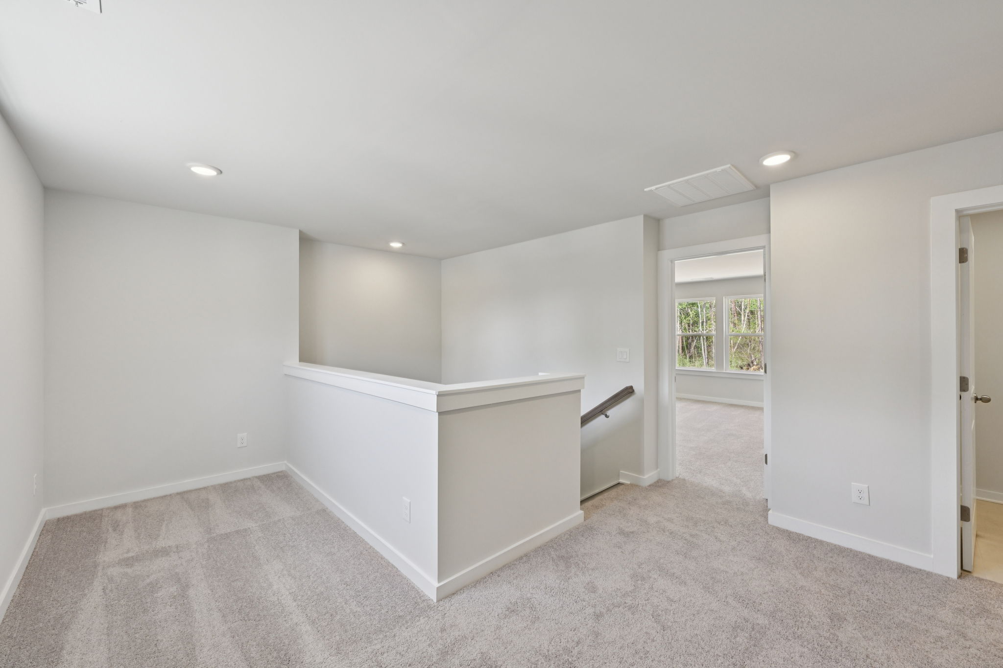 A room with a white counter and a window.