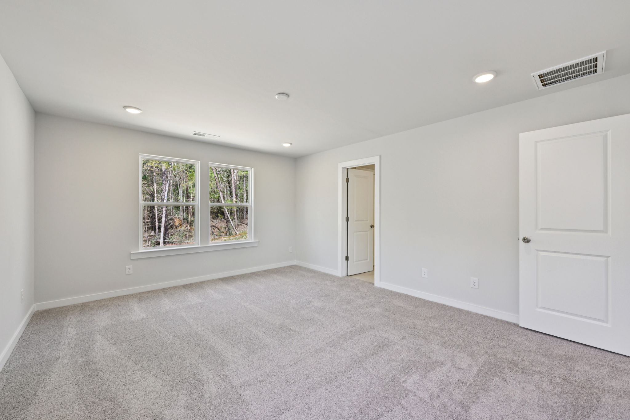 A room with white walls and a window.