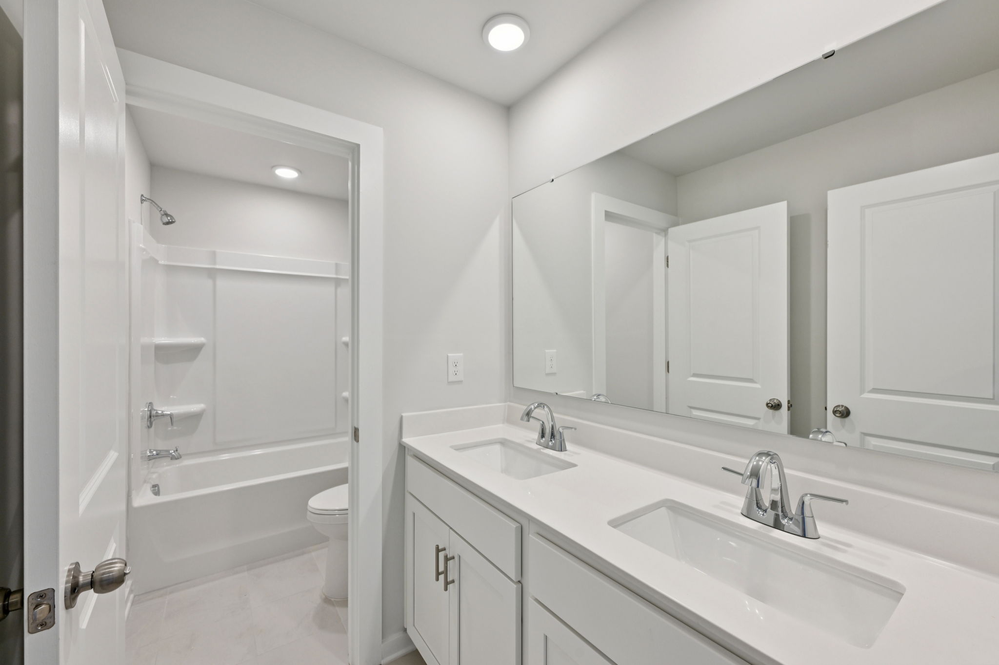 A bathroom with a tub sink and toilet.