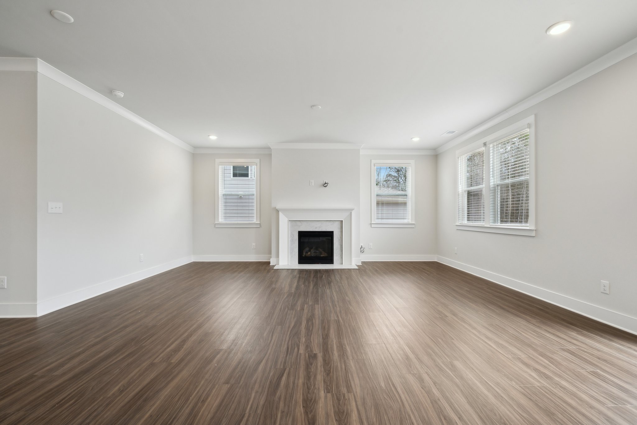 A large empty room with a fireplace.