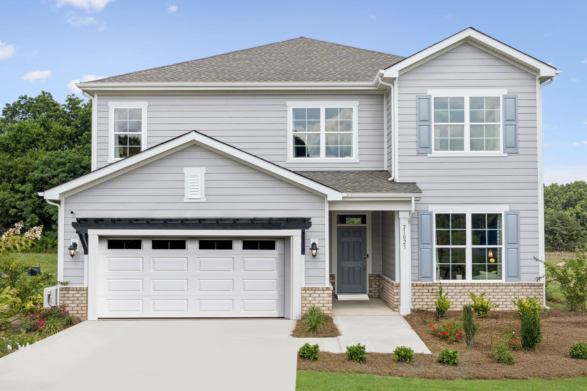 A white house with a garage.