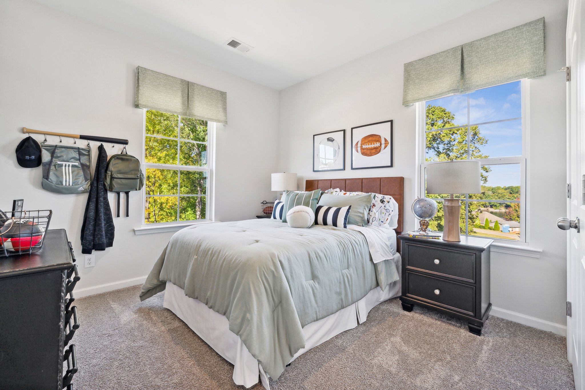 A bedroom with a bed and a window.