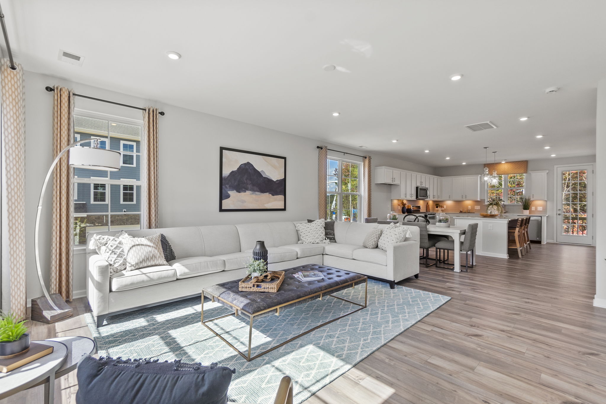 A large living room with a large glass coffee table.