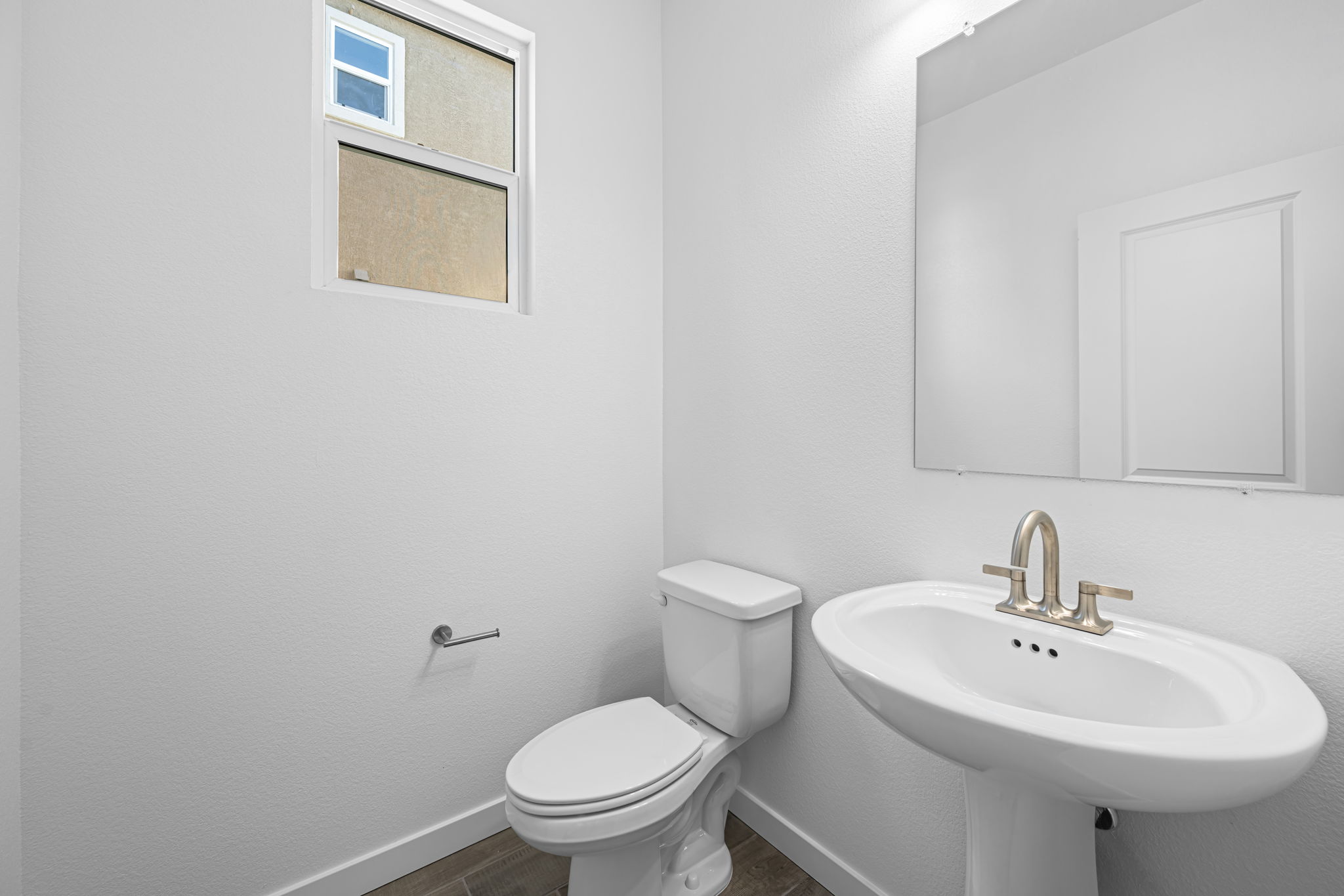 A bathroom with a toilet and sink.