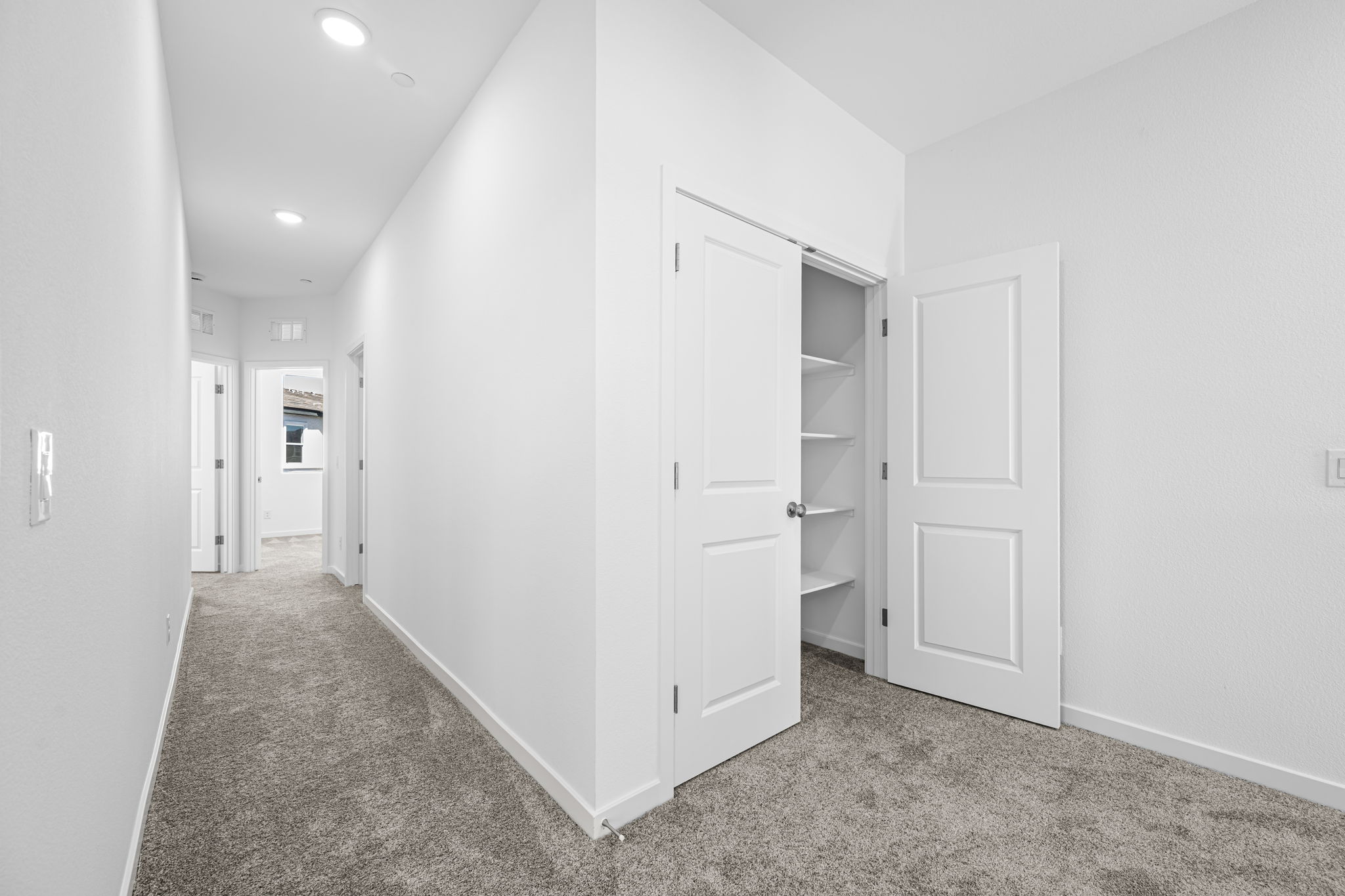 A hallway with white doors.