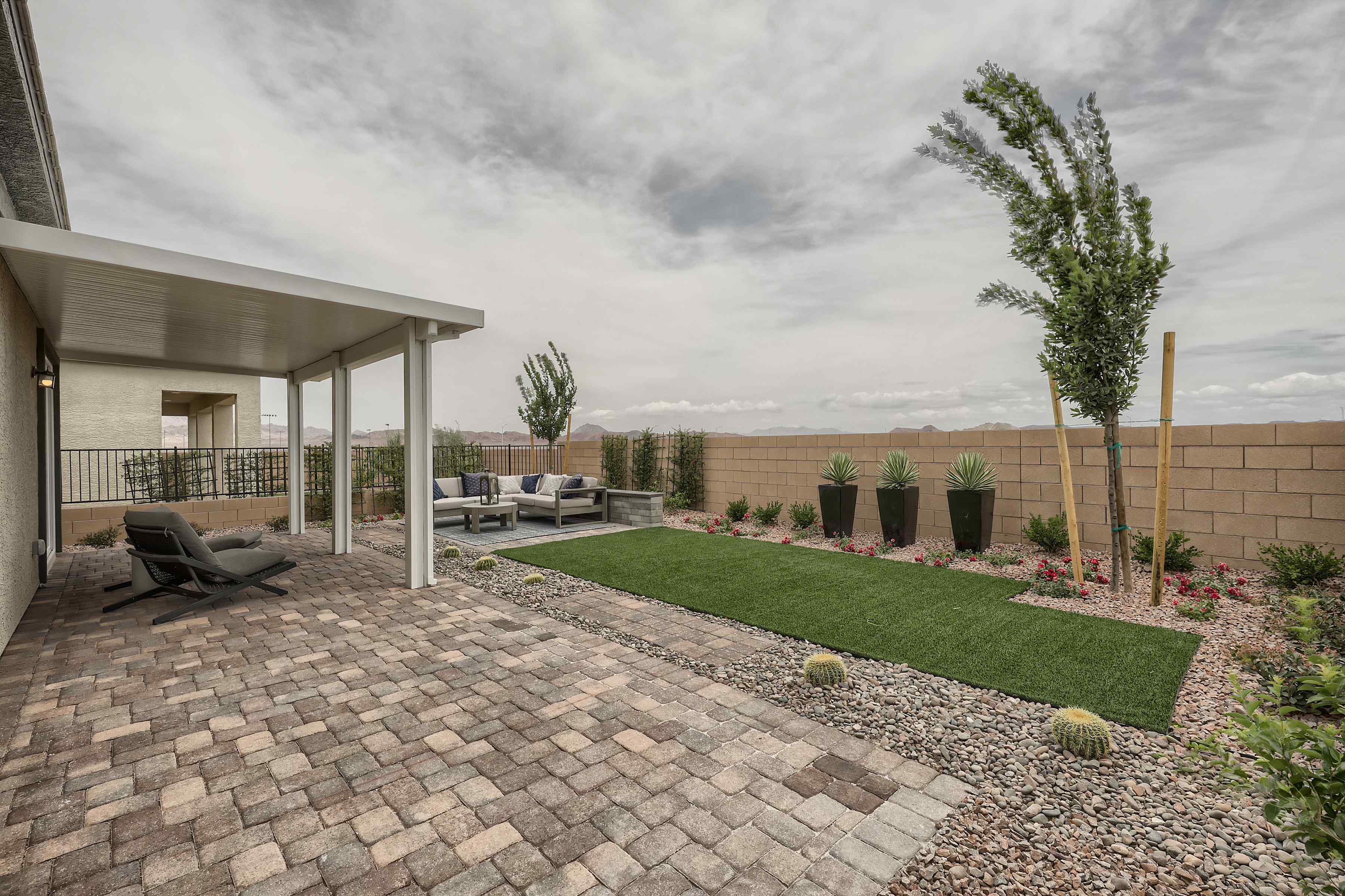 A courtyard with a building and trees.