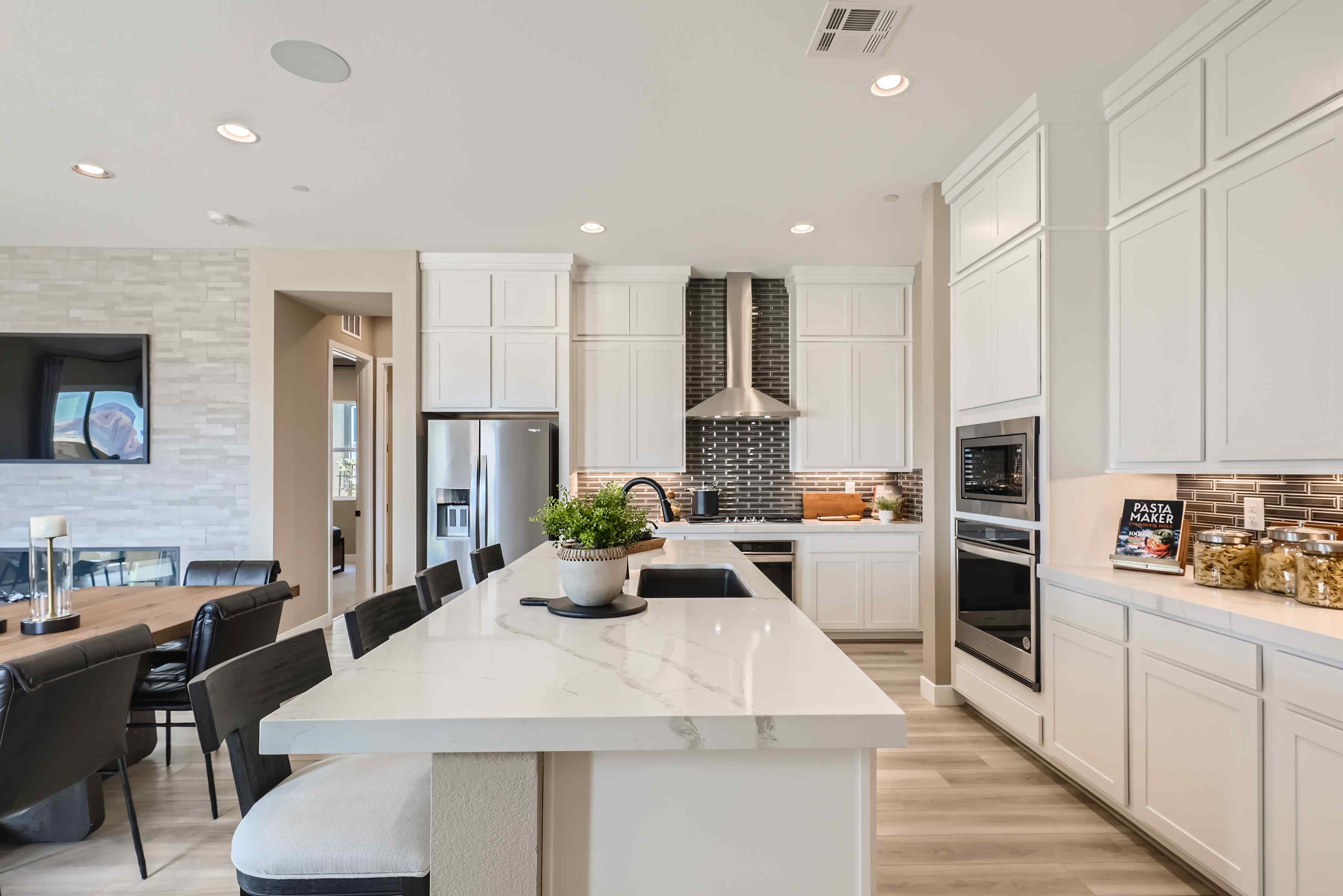 A kitchen with white cabinets.