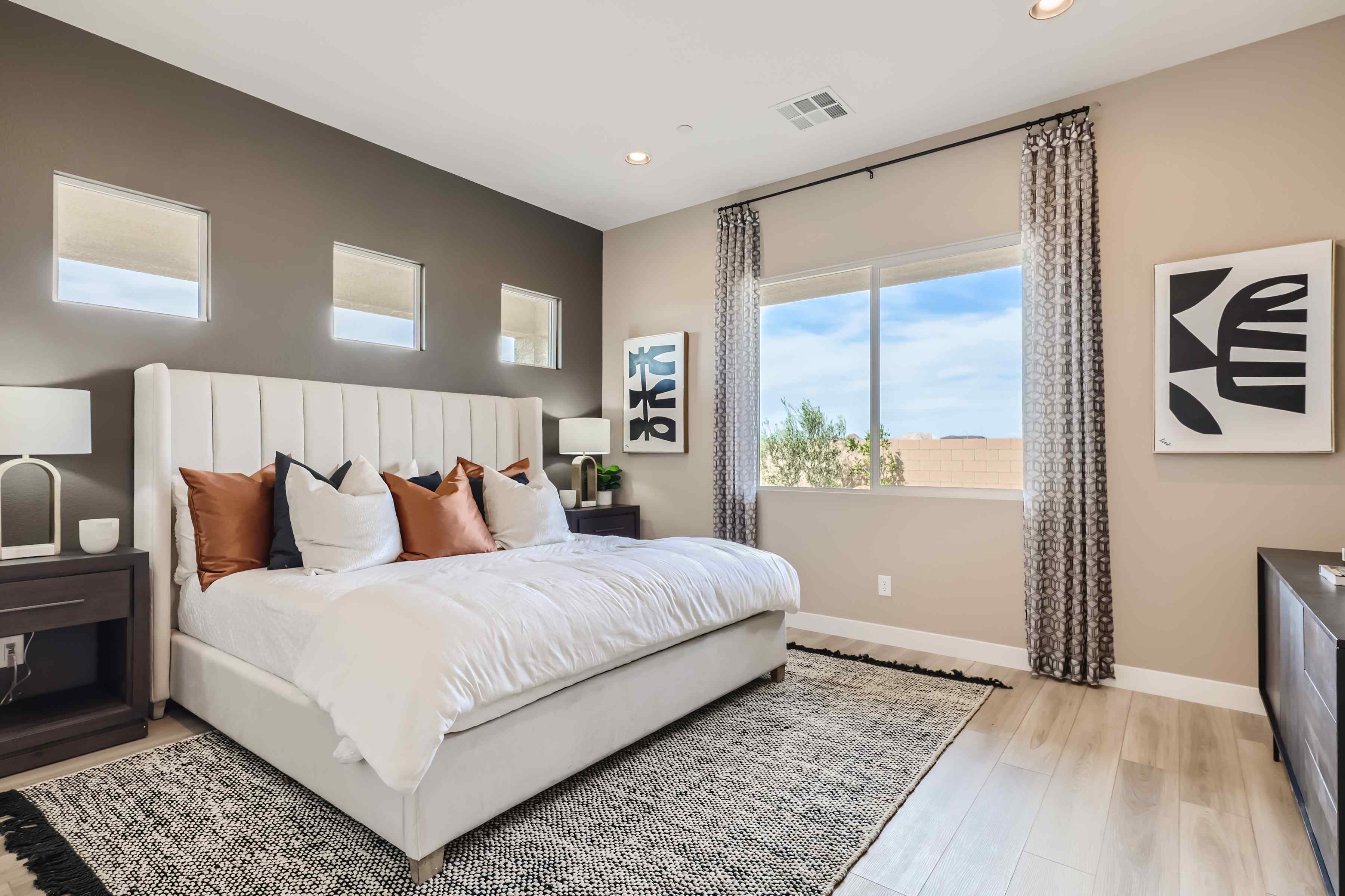 A bedroom with a large window.