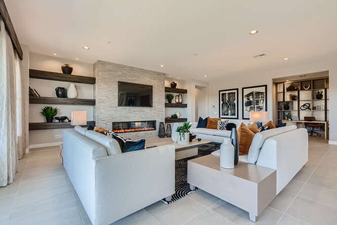 A living room with a white couch and a white table.