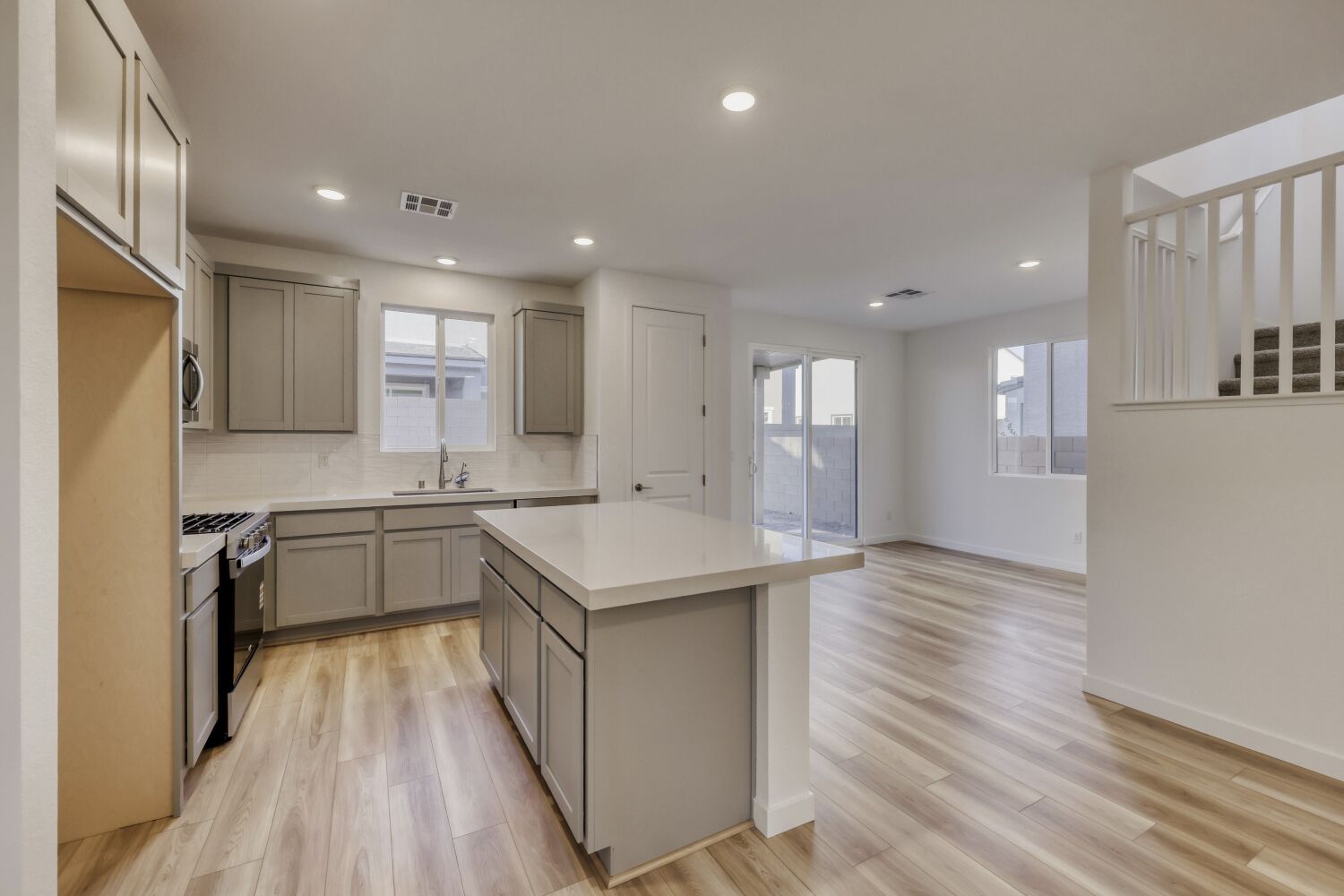 A kitchen with white cabinets.