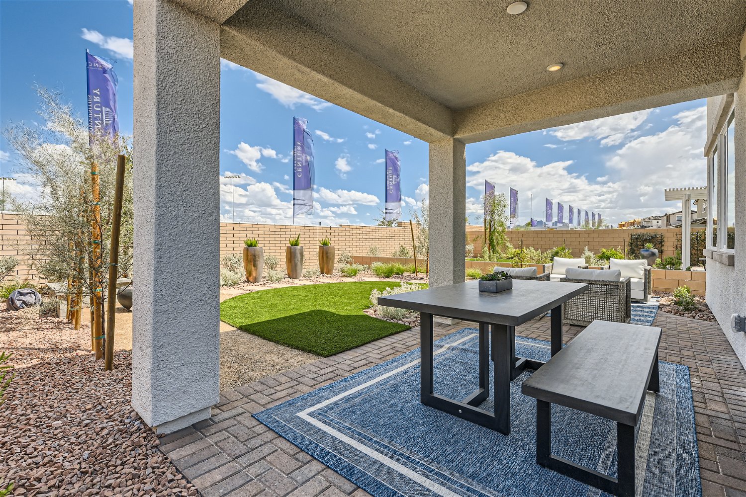 A patio with a table and chairs.