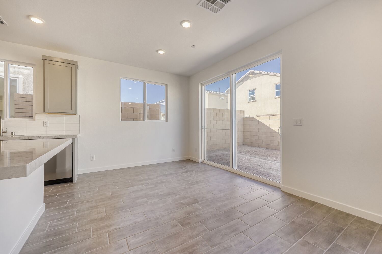 A room with a glass door and a tile floor.