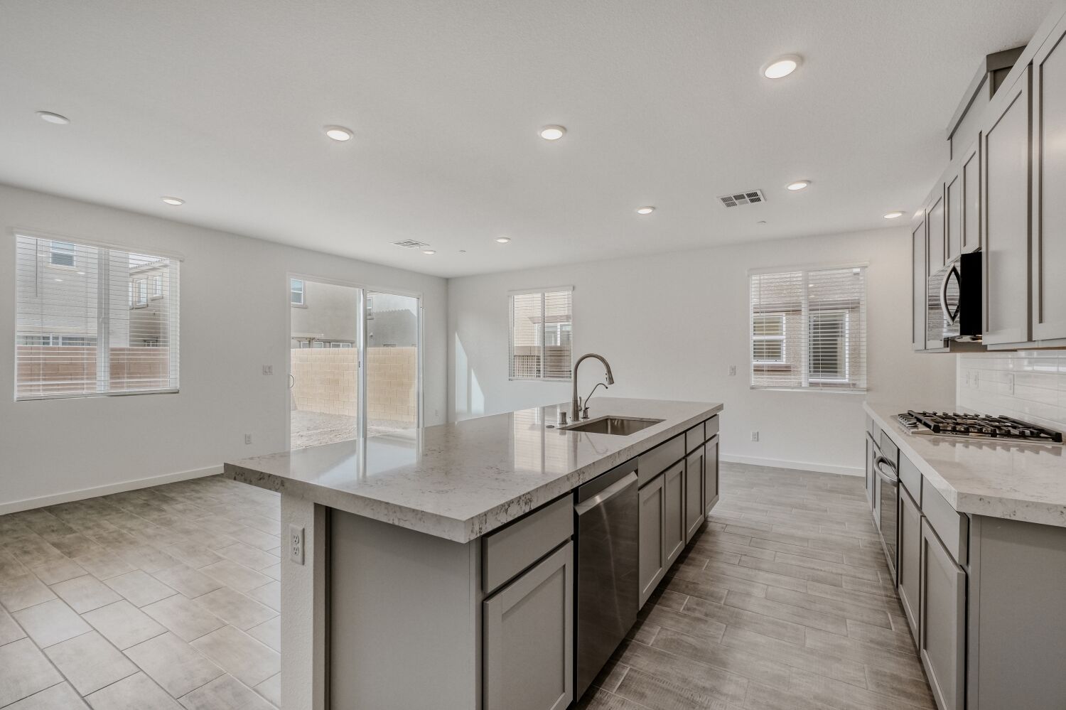 A kitchen with a marble counter top.