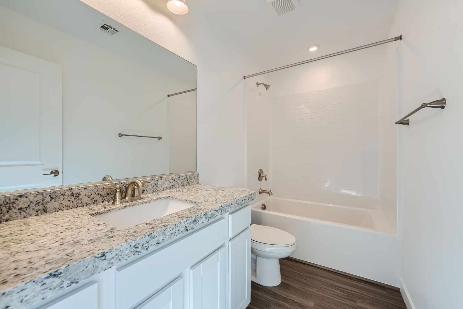 A bathroom with a marble countertop.