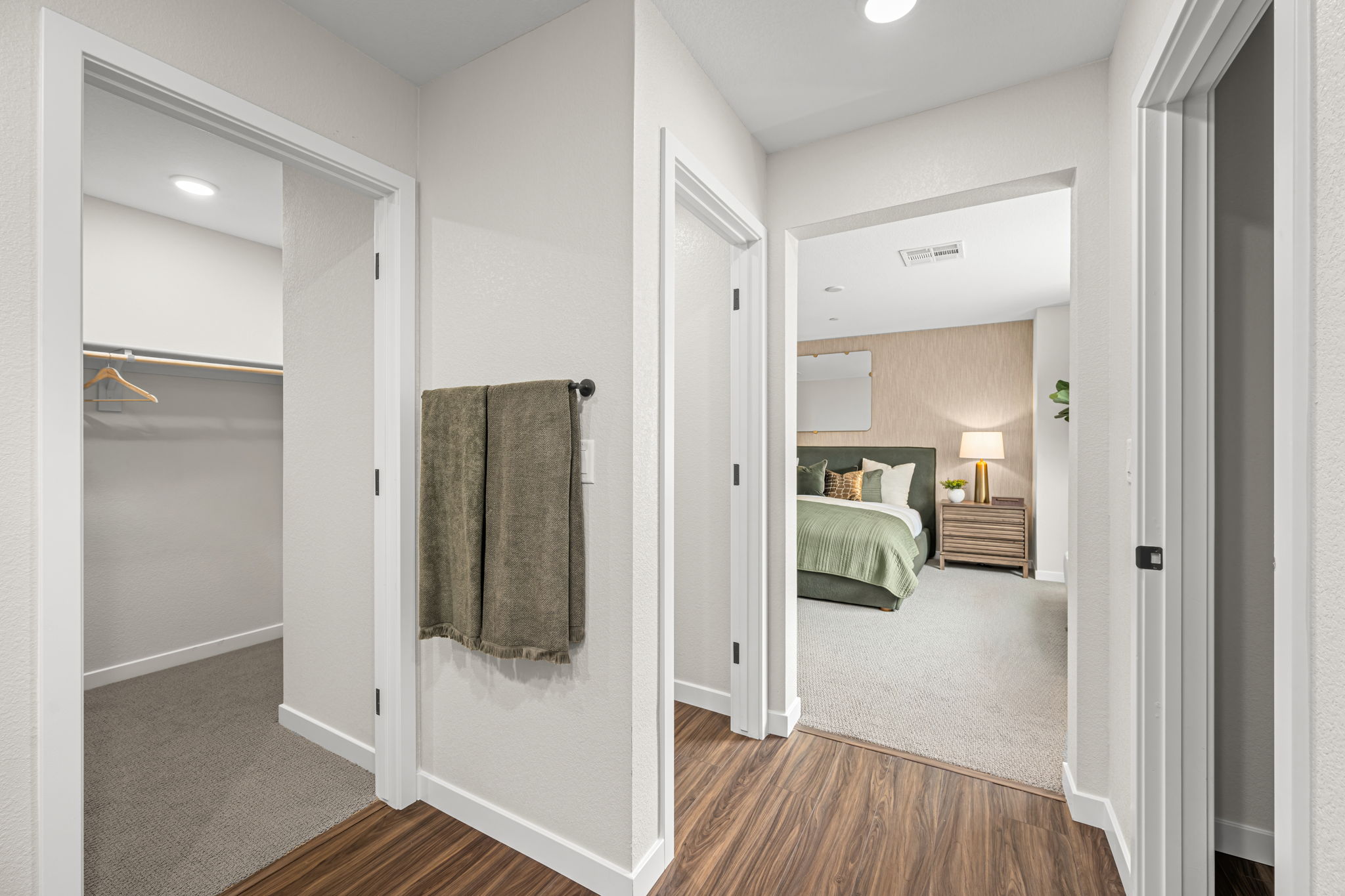 A bedroom with a large mirror.