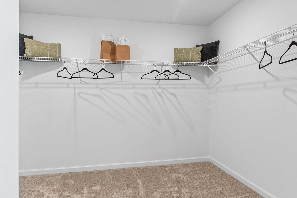 A bed with a white sheet.