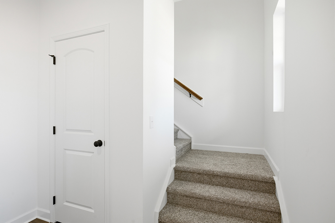 A hallway with white doors.