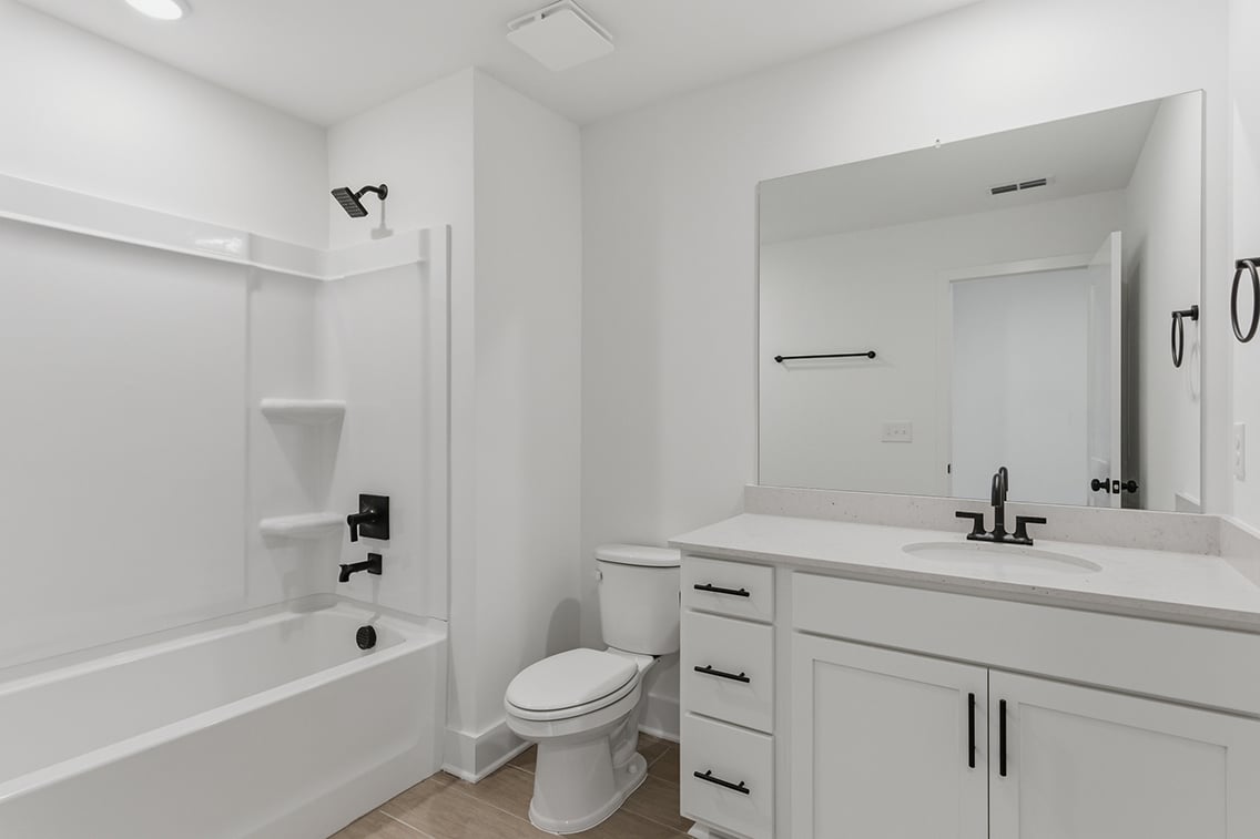 A bathroom with a tub toilet and sink.