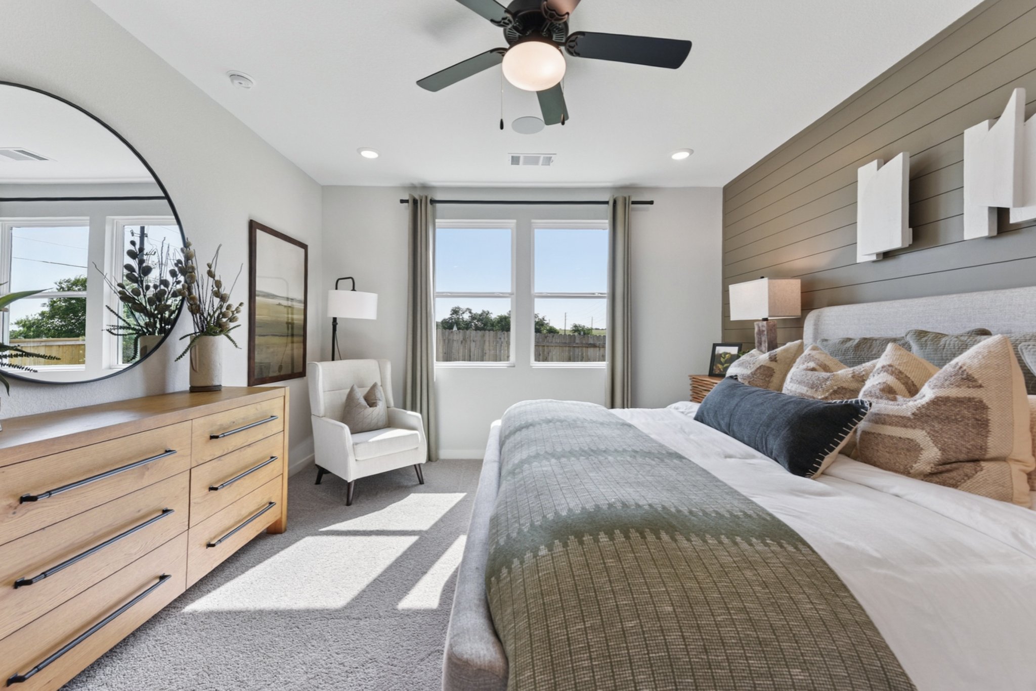 A bedroom with a bed and a fan.