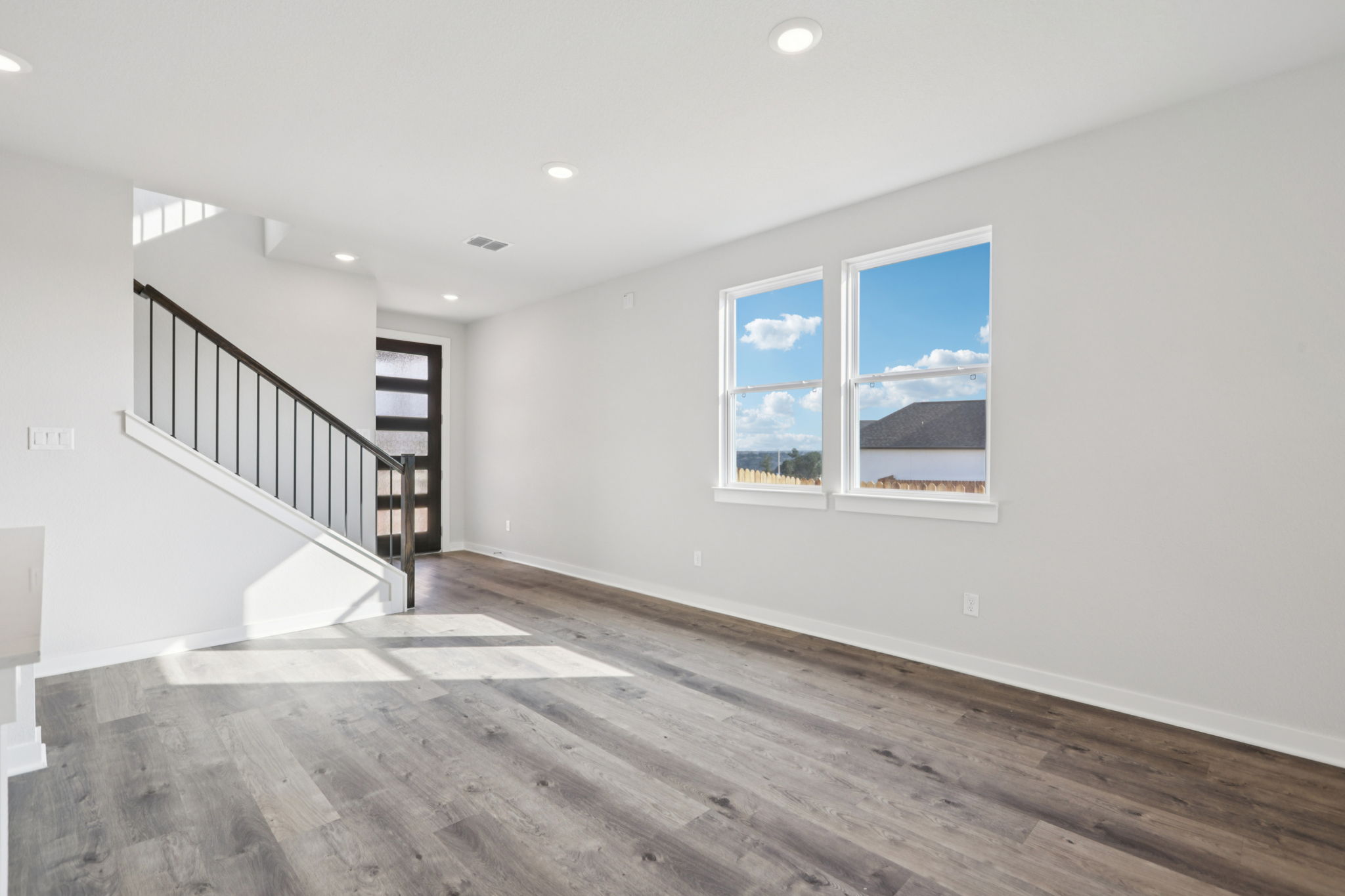 A room with a staircase and a window.