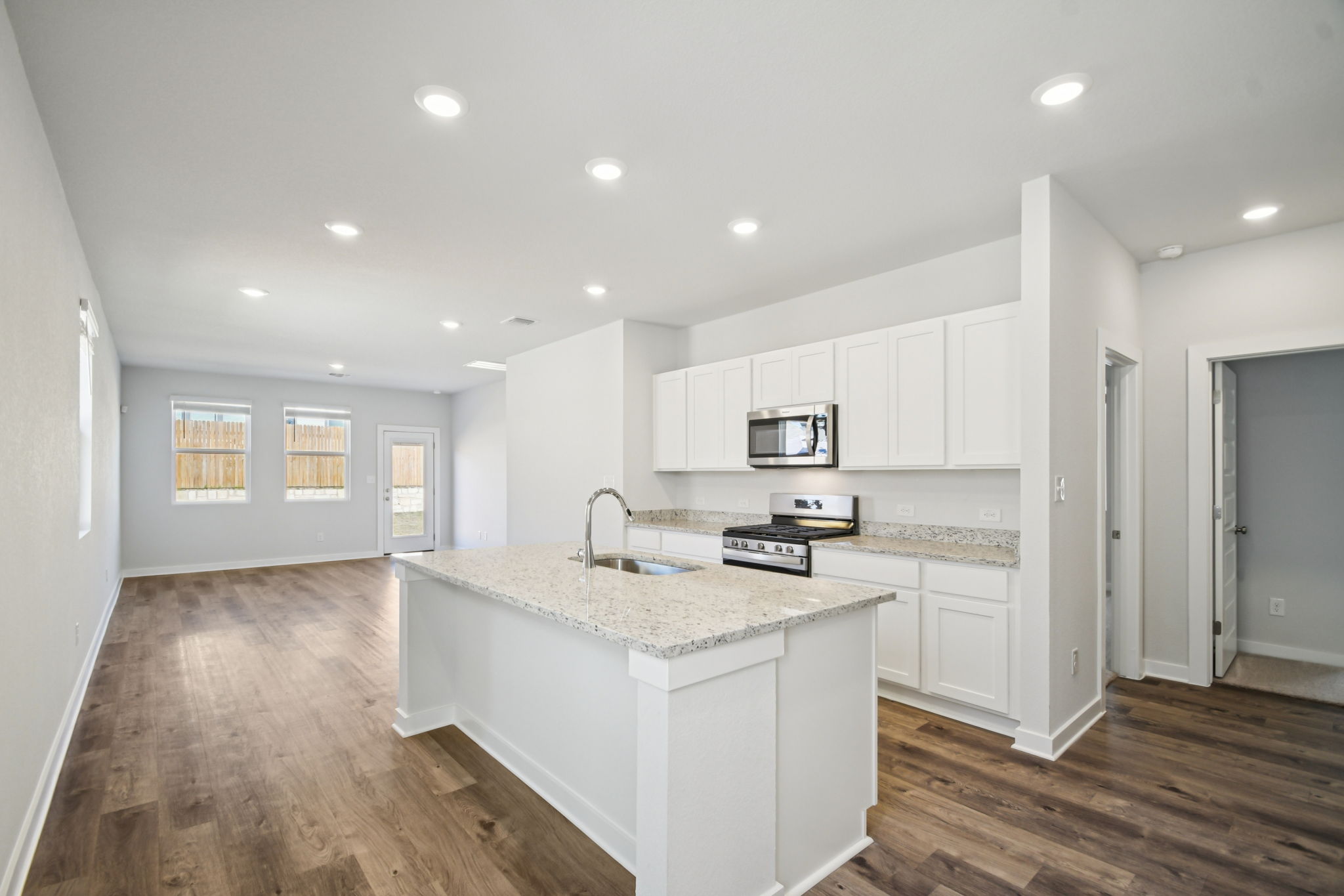 A kitchen with white cabinets.