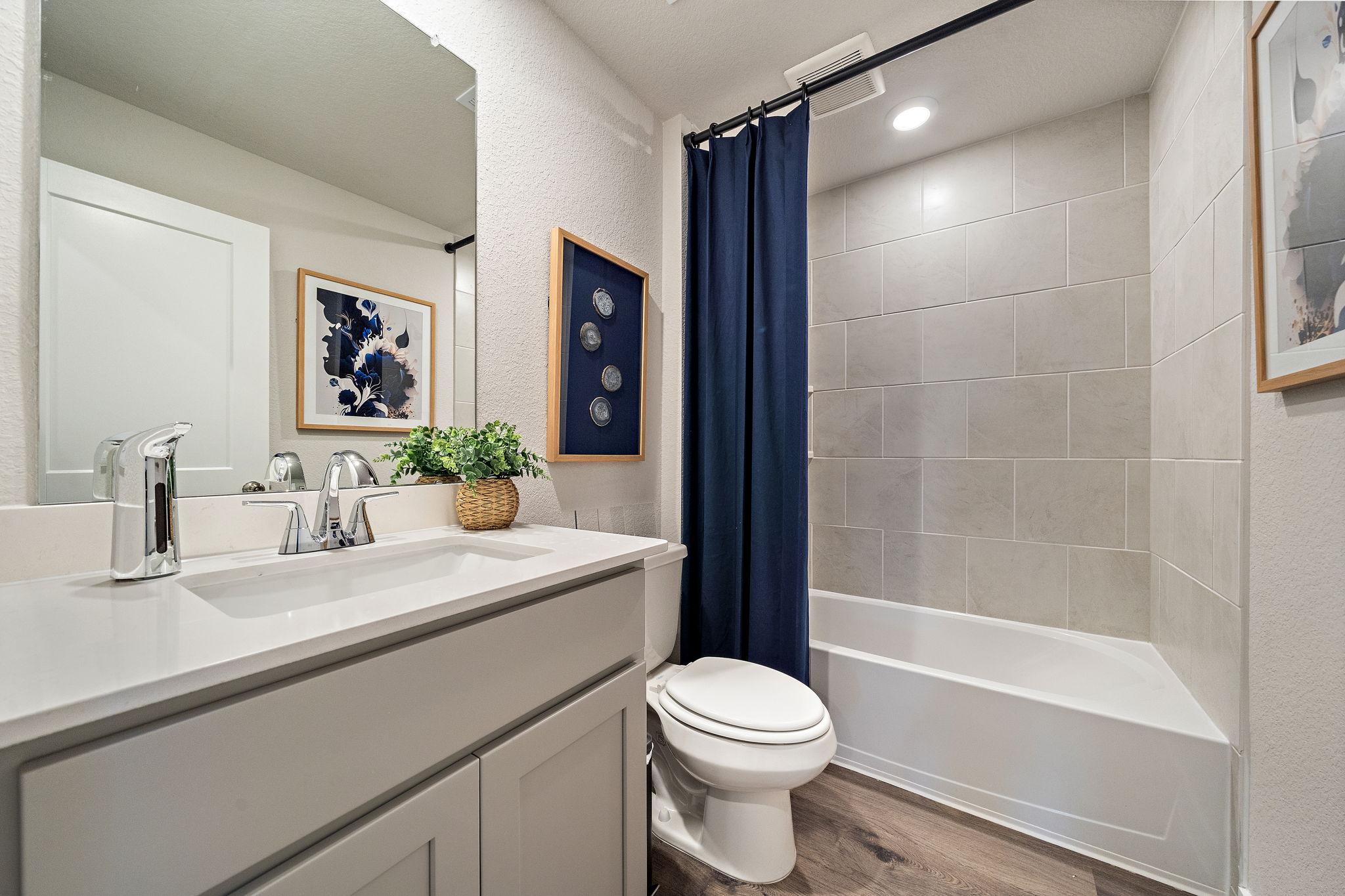 A bathroom with a tub sink and toilet.