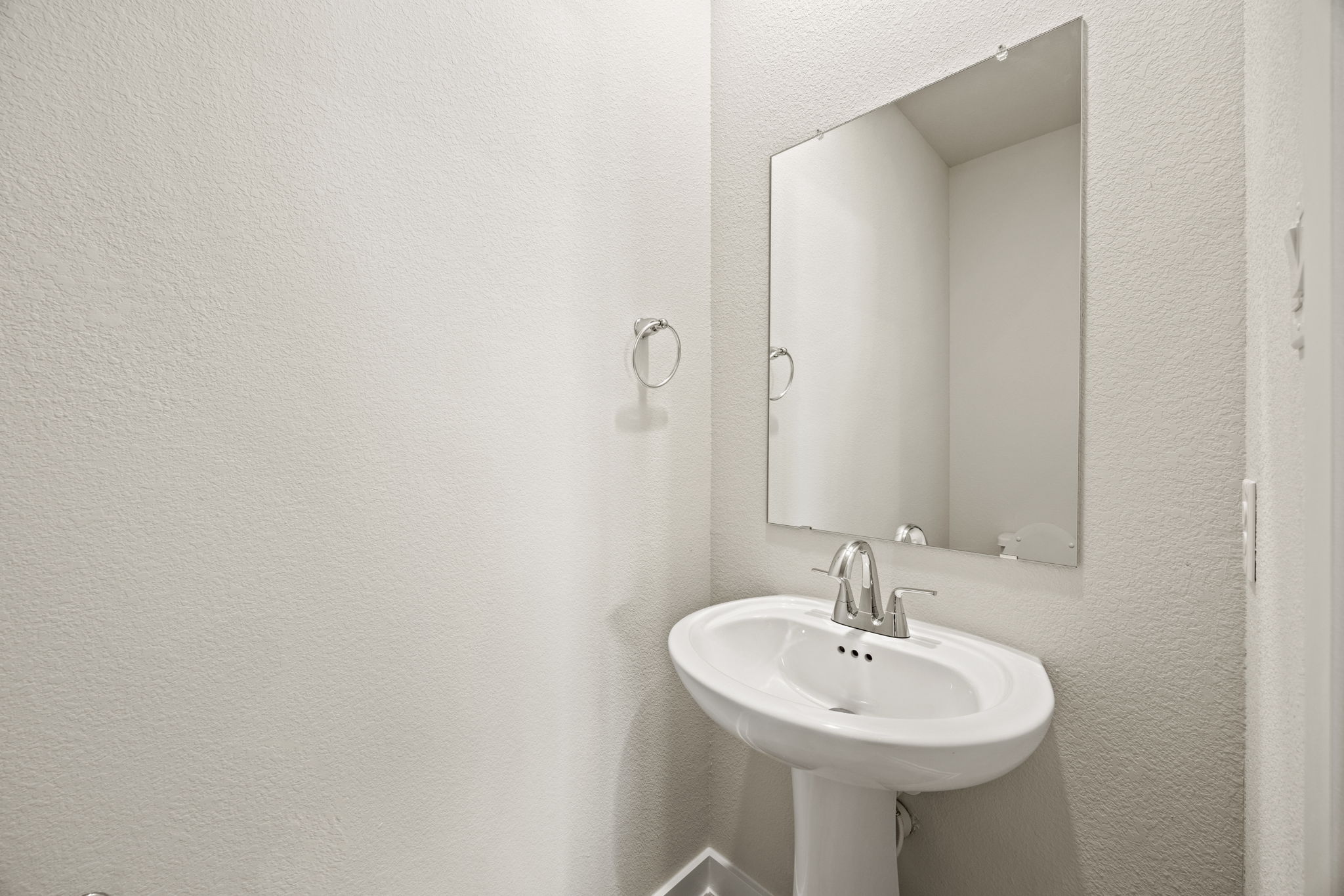 A bathroom with a mirror and sink.